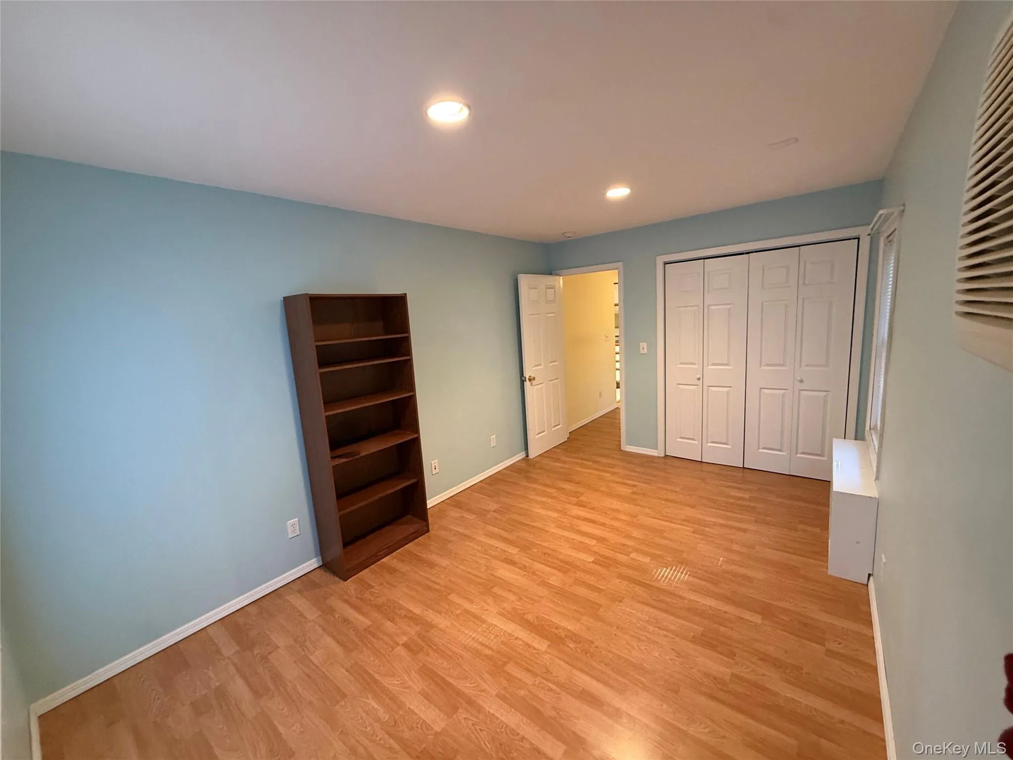 Unfurnished bedroom featuring recessed lighting, light wood finished floors, and a closet Unfurnished bedroom featuring recessed lighting, light wood finished floors, and a closet