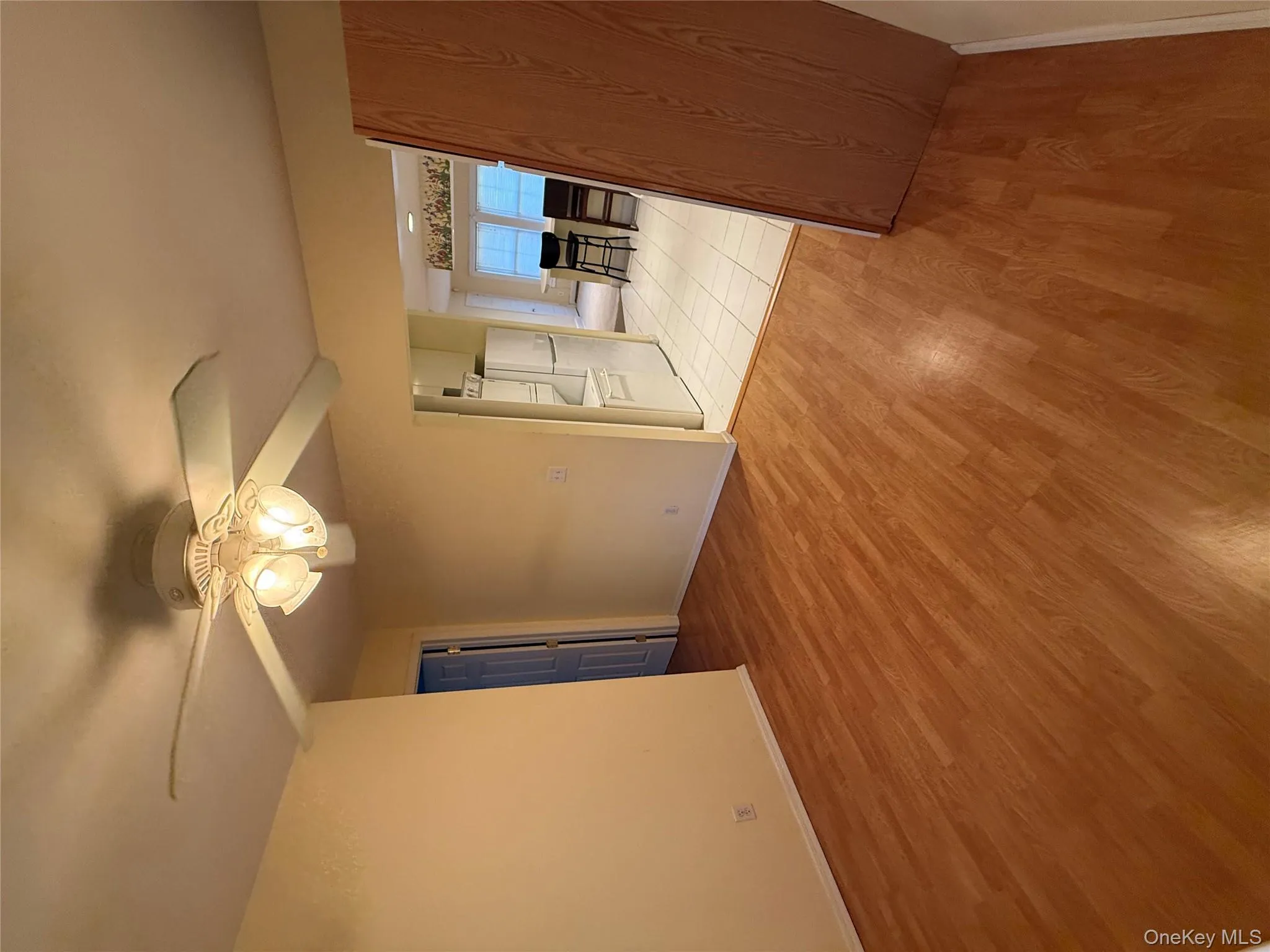 Spare room with light wood finished floors and ceiling fan Spare room with light wood finished floors and ceiling fan