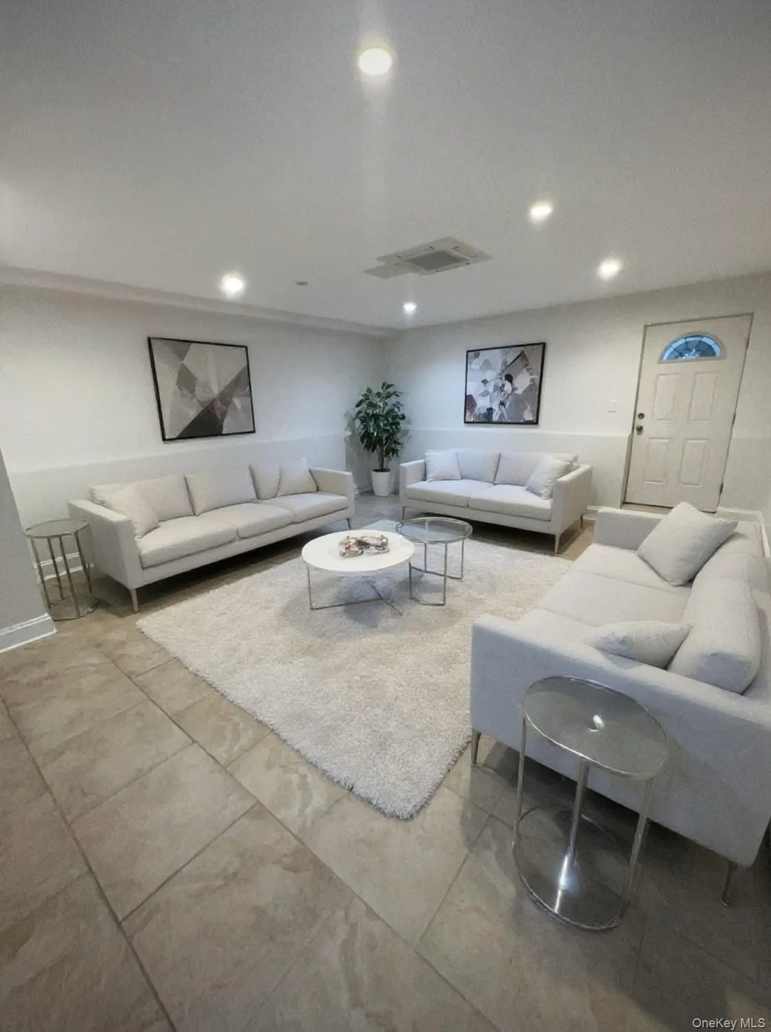 Tiled living room featuring recessed lighting Tiled living room featuring recessed lighting