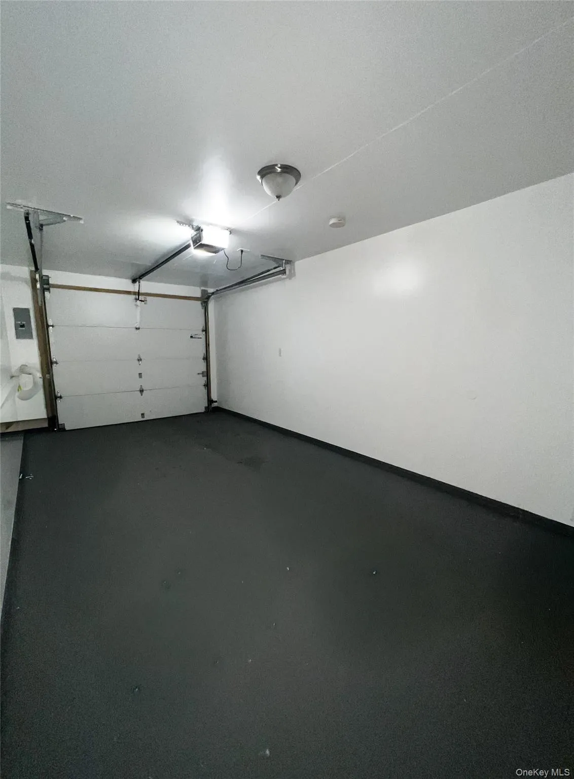Garage with a garage door opener and electric panel Garage with a garage door opener and electric panel