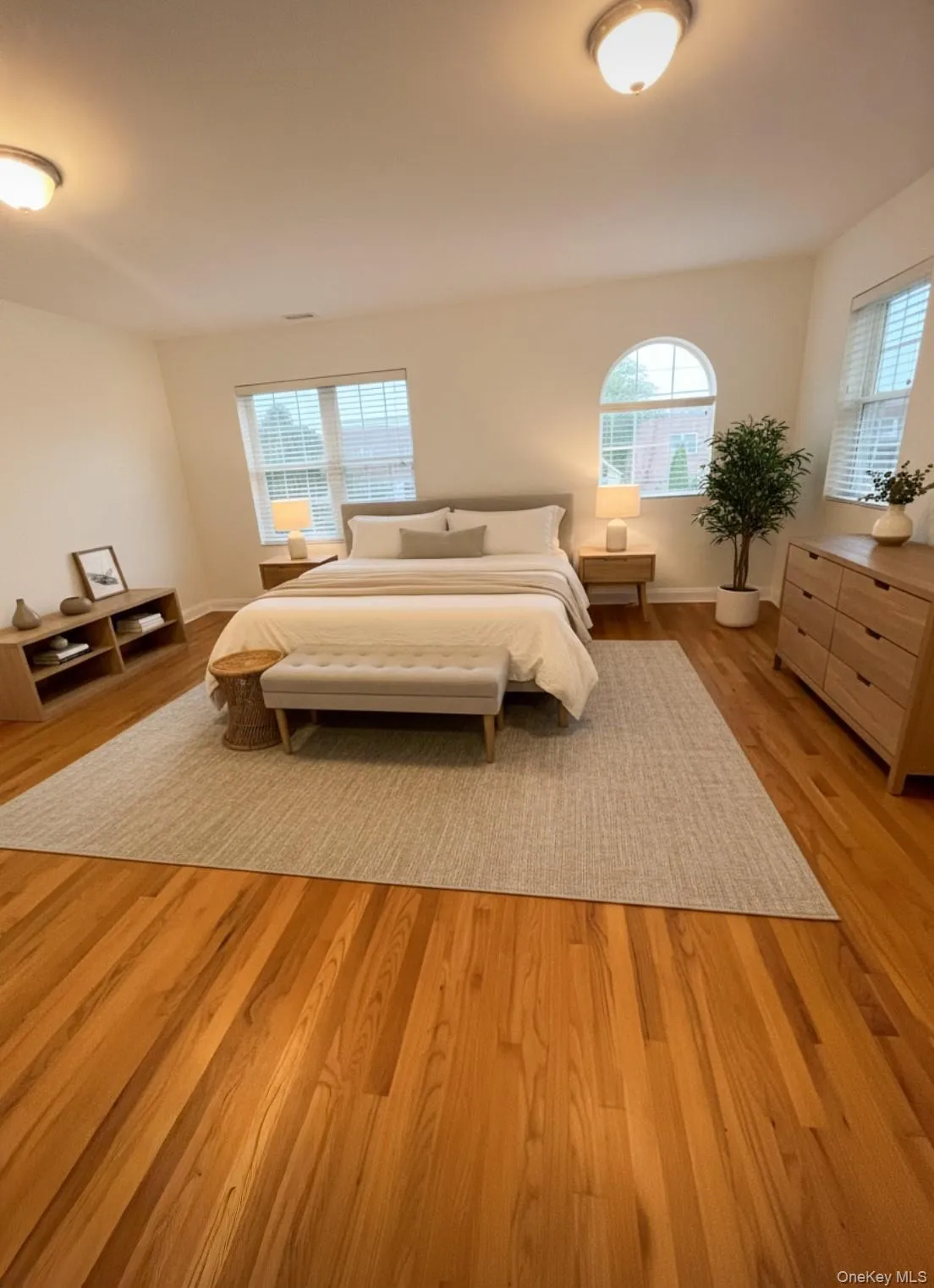 Bedroom featuring light wood-style floors and baseboards Bedroom featuring light wood-style floors and baseboards