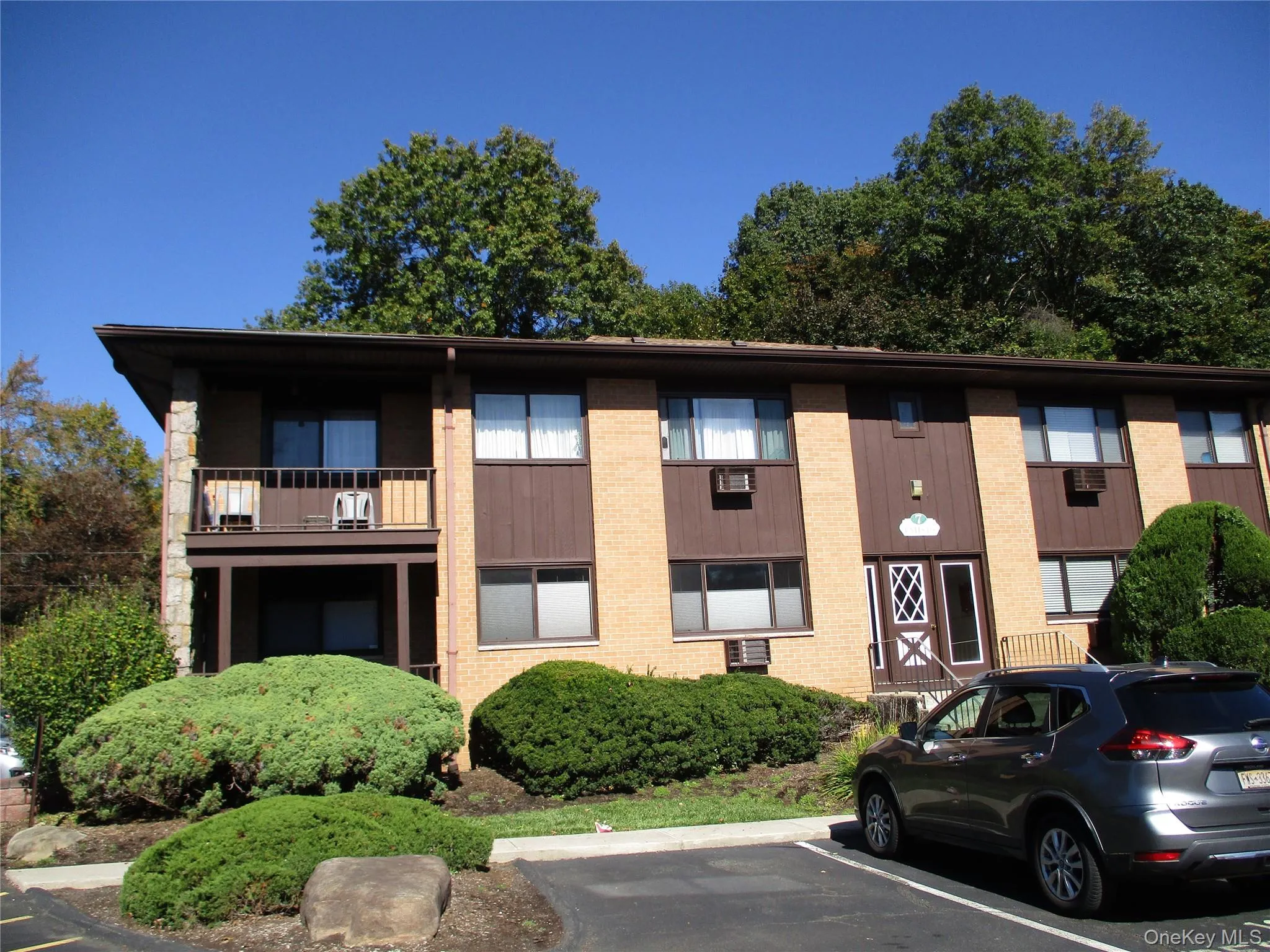 View of building exterior with uncovered parking View of building exterior with uncovered parking