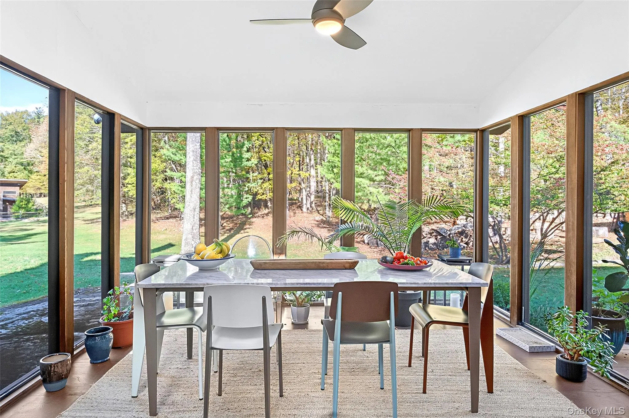 Sunroom / solarium featuring wood finished floors and vaulted ceiling Sunroom / solarium featuring wood finished floors and vaulted ceiling