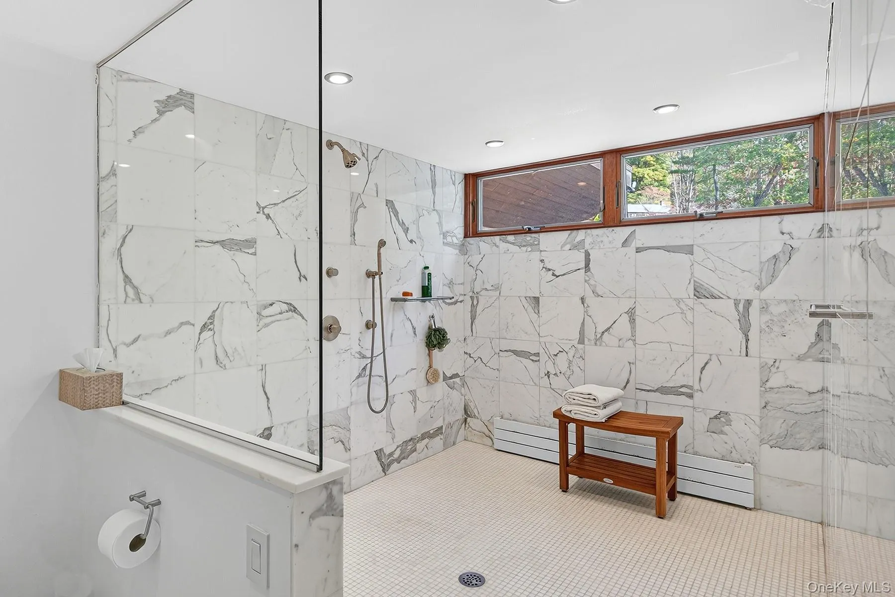 Main first floor full bath with a marble finish shower. Main first floor full bath with a marble finish shower.
