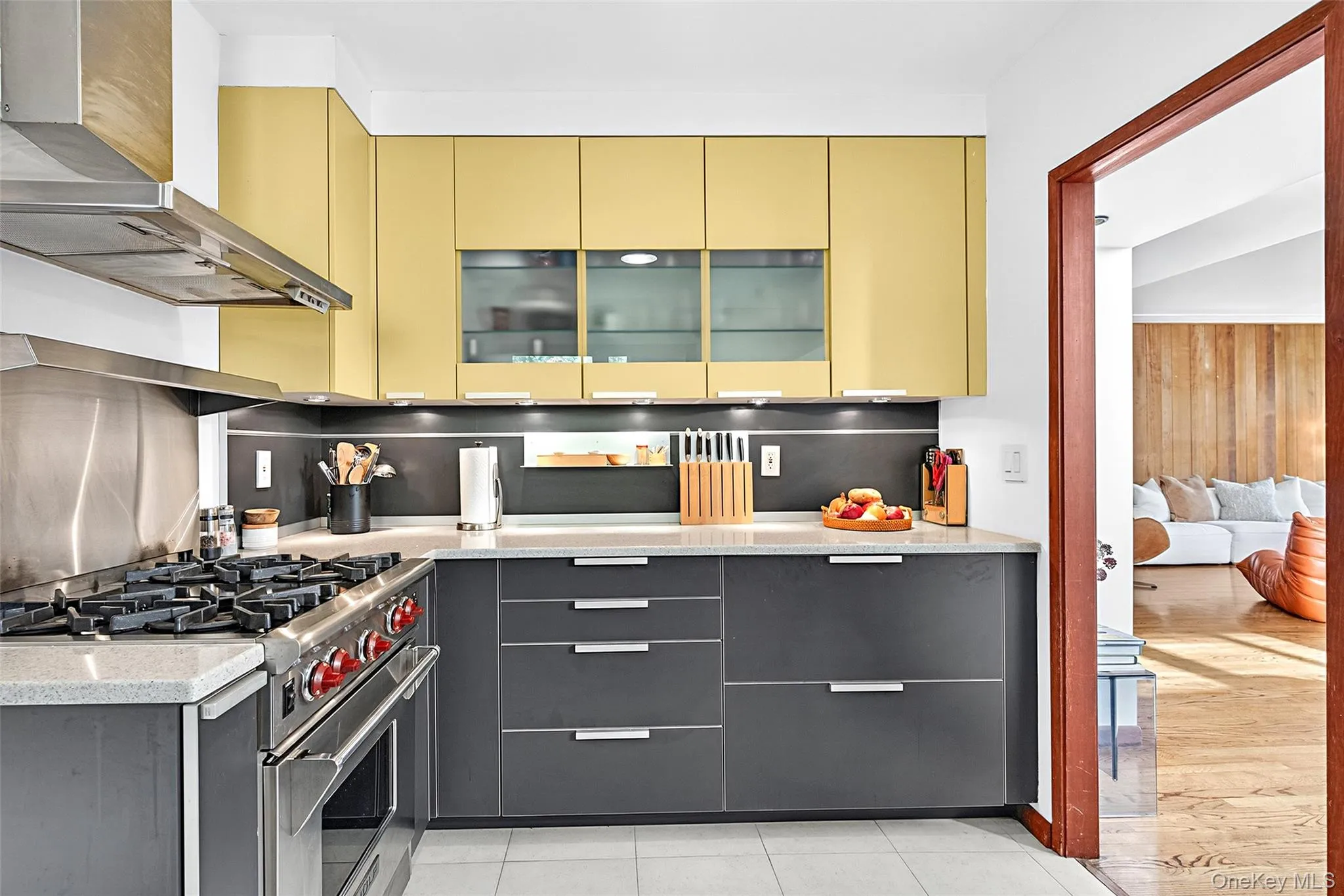 Kitchen featuring high end stainless steel range, wall chimney exhaust hood, modern cabinets. Kitchen featuring high end stainless steel range, wall chimney exhaust hood, modern cabinets.
