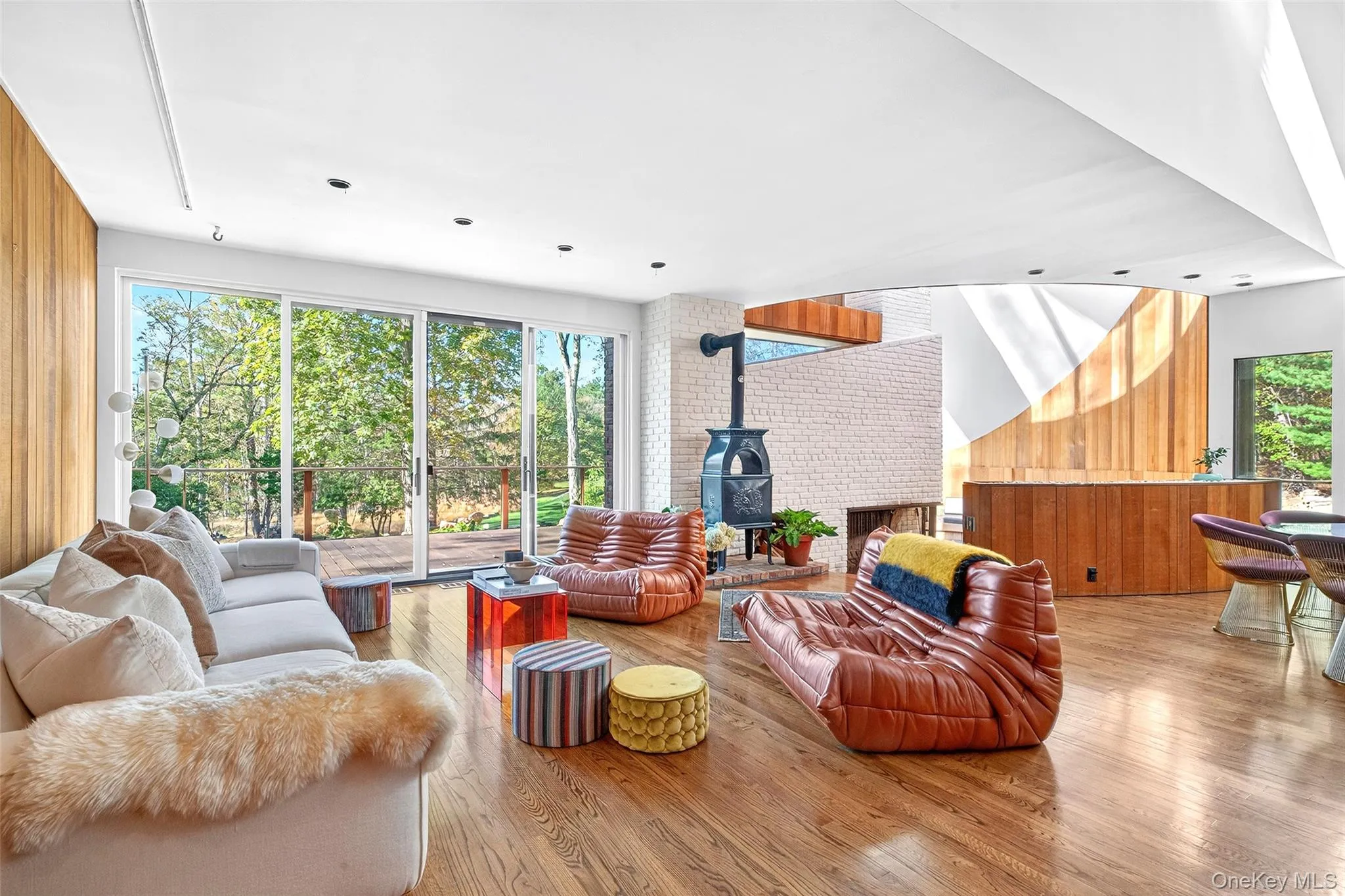 Living room with sliding doors to deck and wood stove. Living room with sliding doors to deck and wood stove.