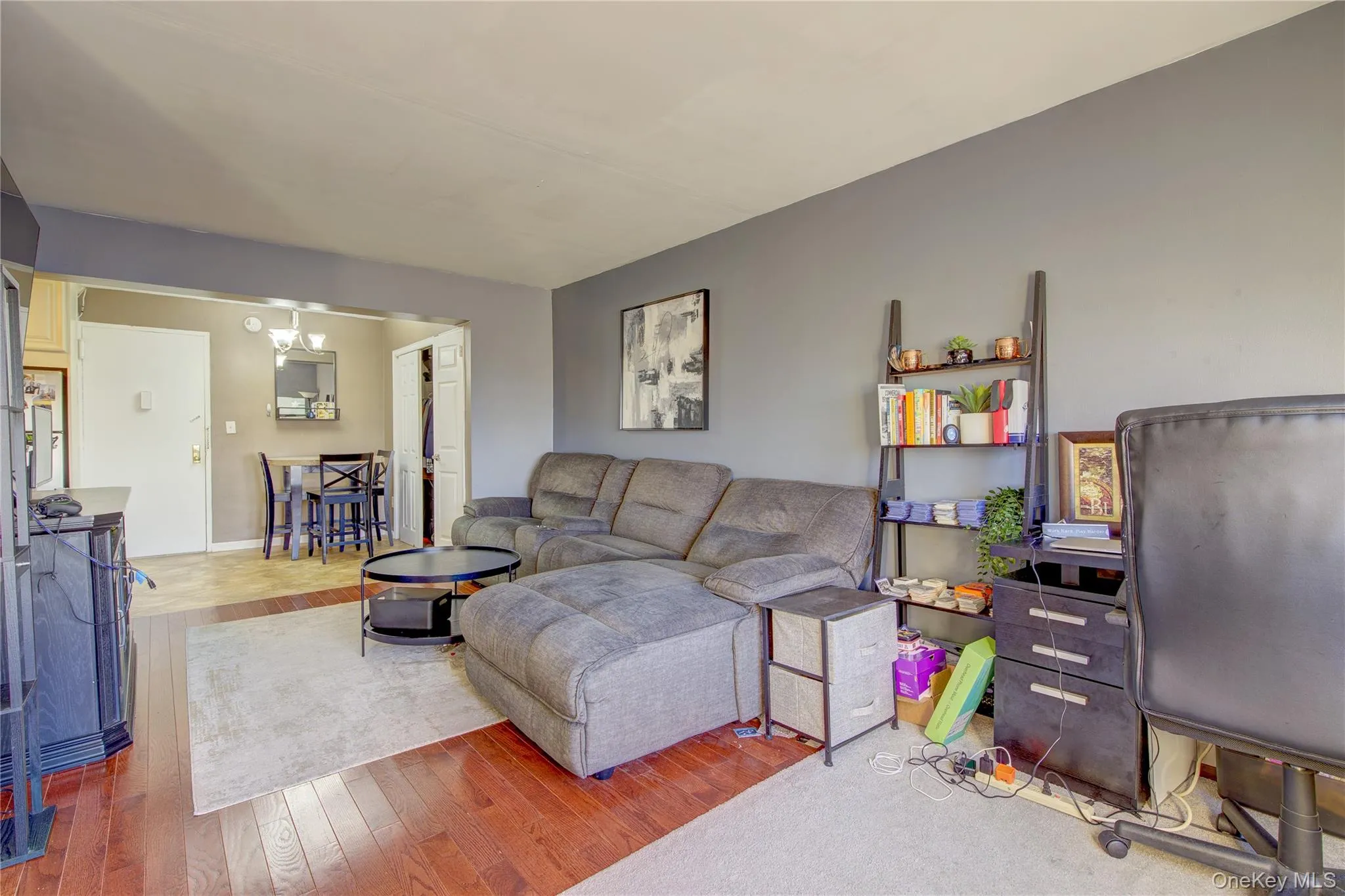 Living room with hardwood / wood-style floors and a chandelier Living room with hardwood / wood-style floors and a chandelier