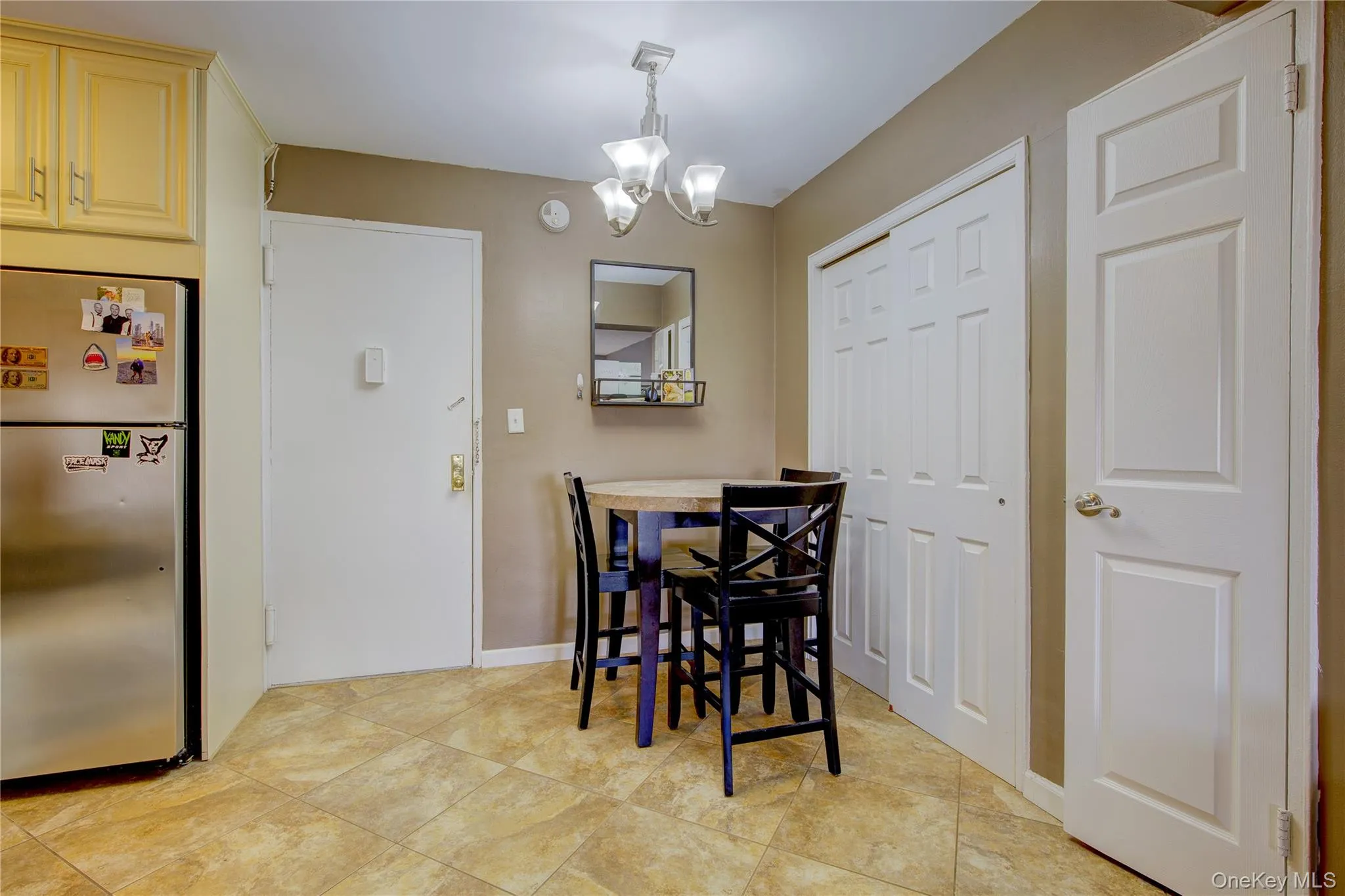 Dining room featuring a chandelier and light tile patterned flooring Dining room featuring a chandelier and light tile patterned flooring