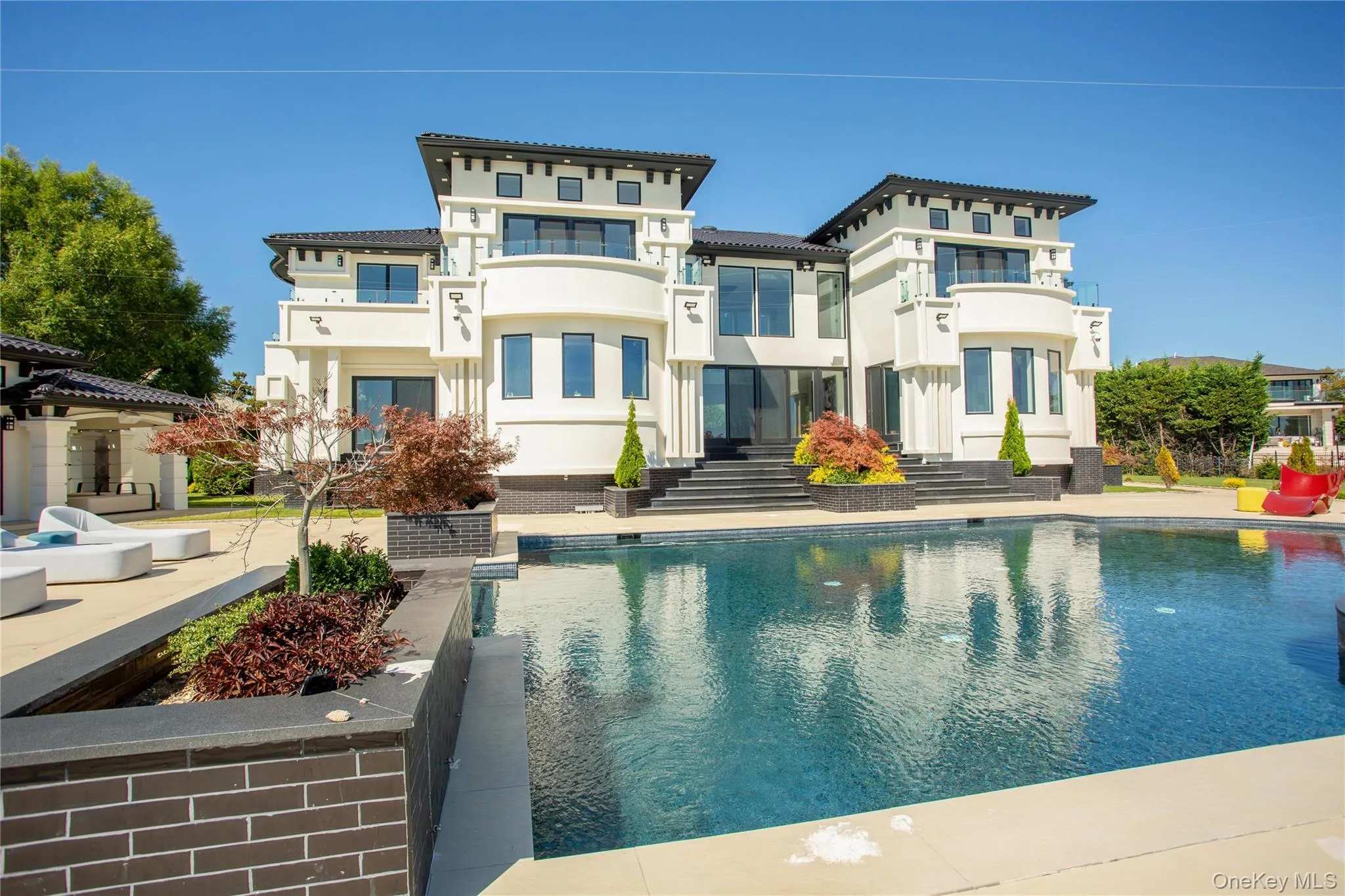 Rear view of property featuring an outdoor pool, stucco siding, and a patio Rear view of property featuring an outdoor pool, stucco siding, and a patio