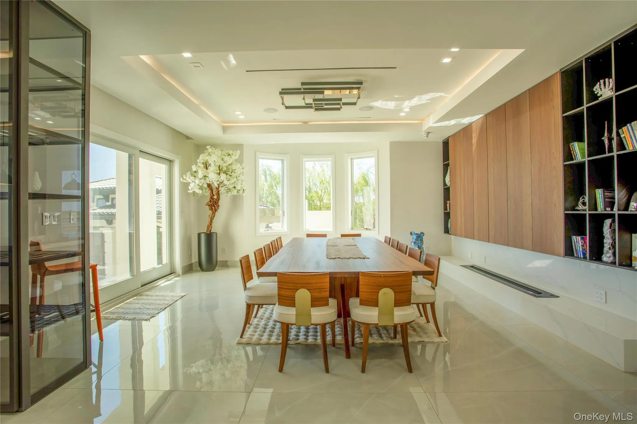 Dining room with a raised ceiling and light tile patterned floors Dining room with a raised ceiling and light tile patterned floors