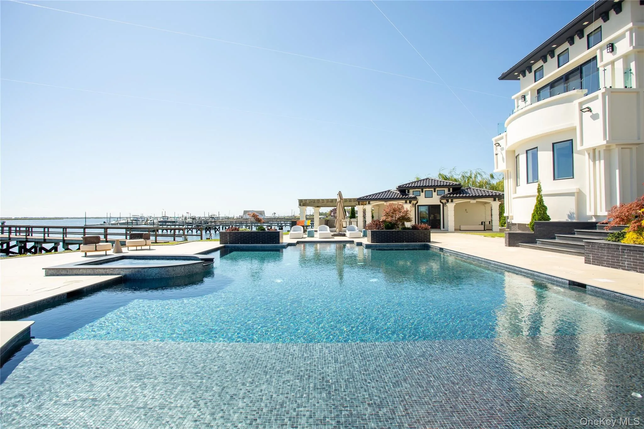 View of pool featuring a pool with connected hot tub and a patio View of pool featuring a pool with connected hot tub and a patio