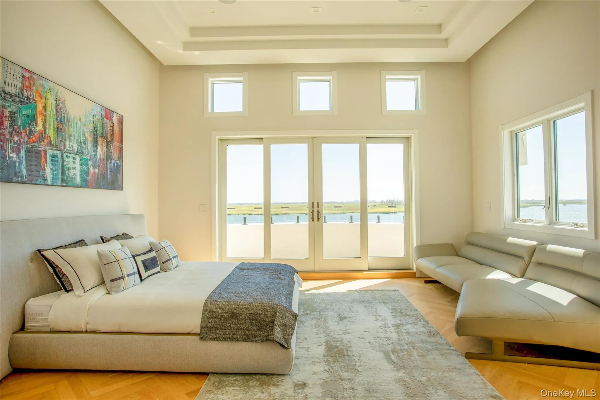 Bedroom with a water view, access to outside, french doors, a raised ceiling, and a high ceiling Bedroom with a water view, access to outside, french doors, a raised ceiling, and a high ceiling