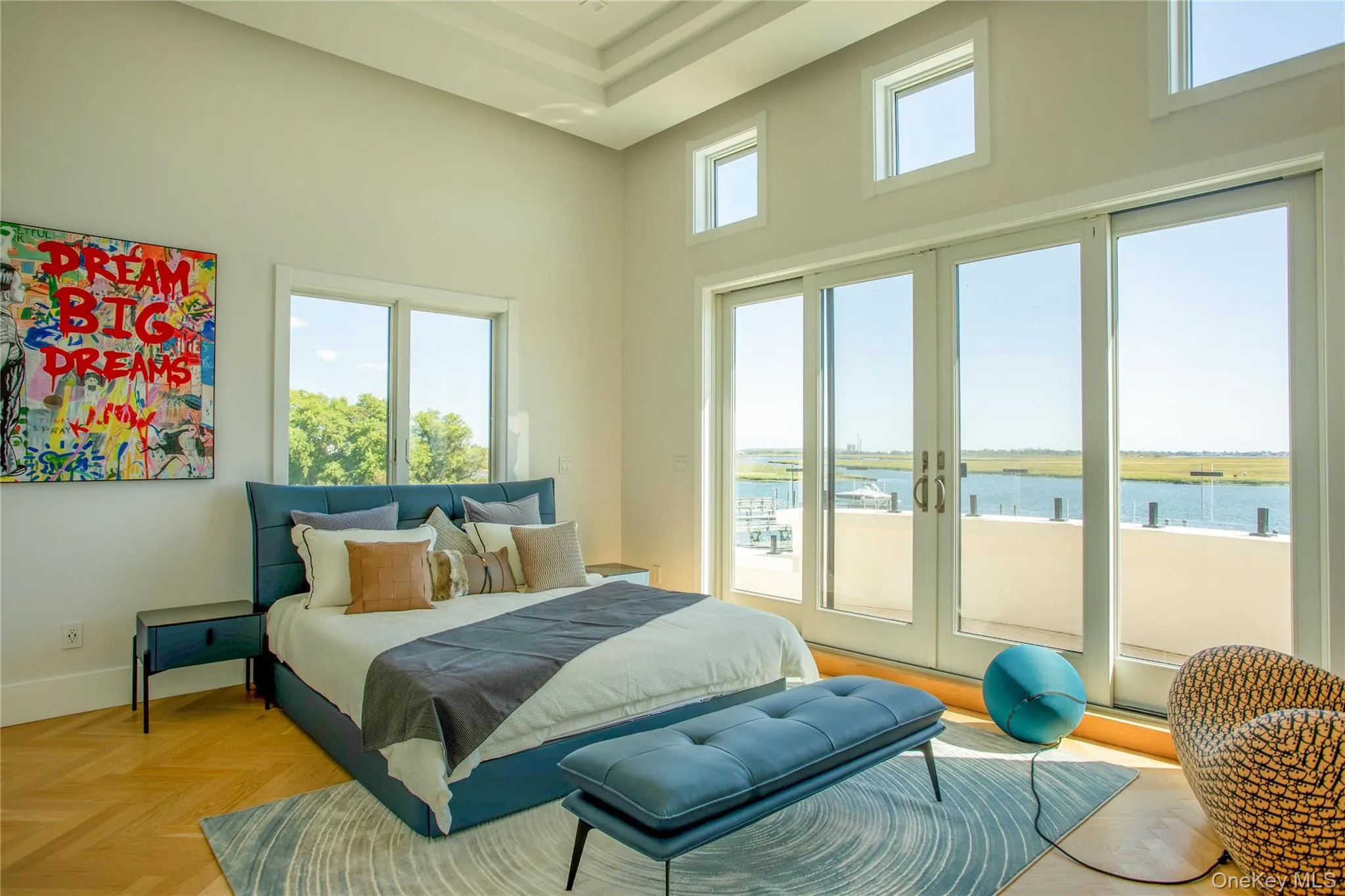 Bedroom with a water view, a high ceiling, and access to outside Bedroom with a water view, a high ceiling, and access to outside