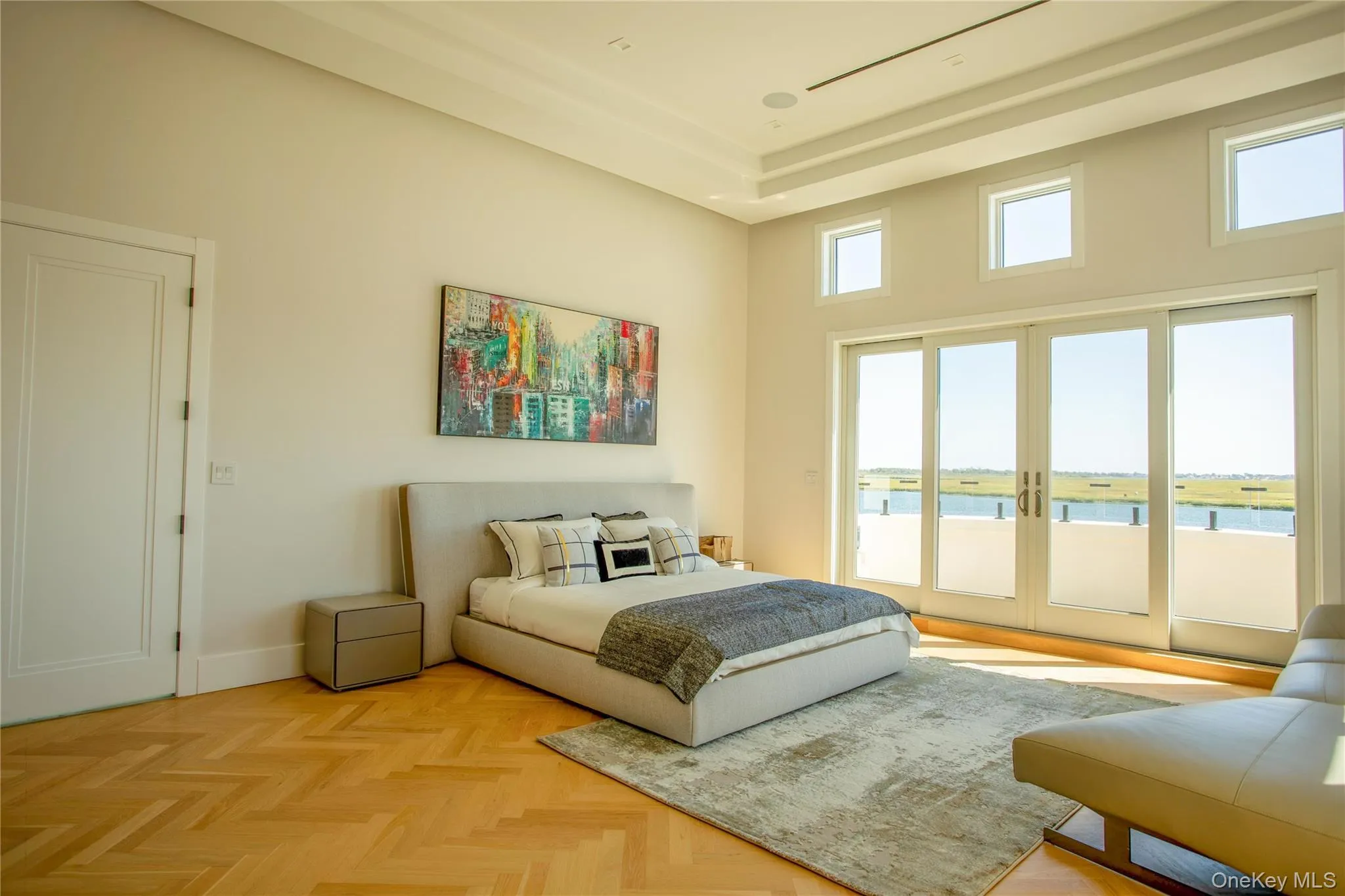 Bedroom featuring a water view, access to outside, and a towering ceiling Bedroom featuring a water view, access to outside, and a towering ceiling