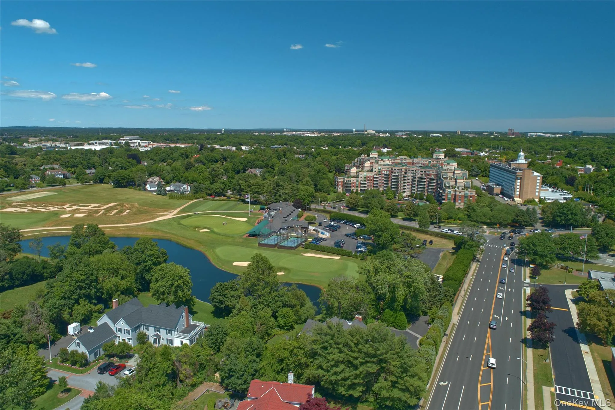 Aerial overview of property's location featuring a large body of water and a golf club Aerial overview of property's location featuring a large body of water and a golf club