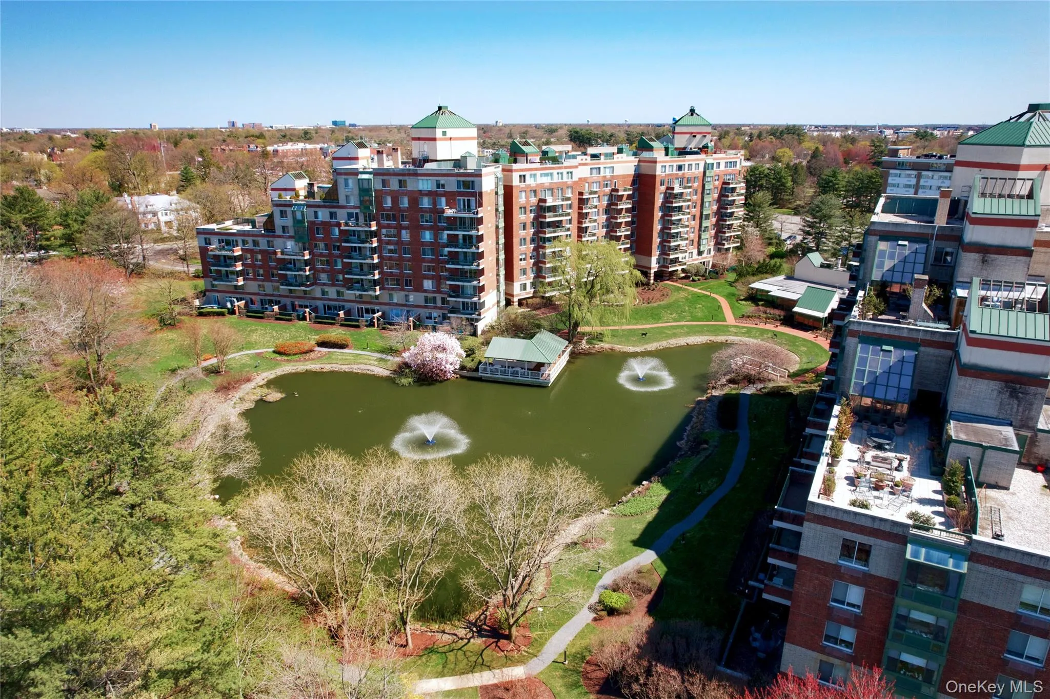 Aerial view of apartment complex and a nearby body of water Aerial view of apartment complex and a nearby body of water