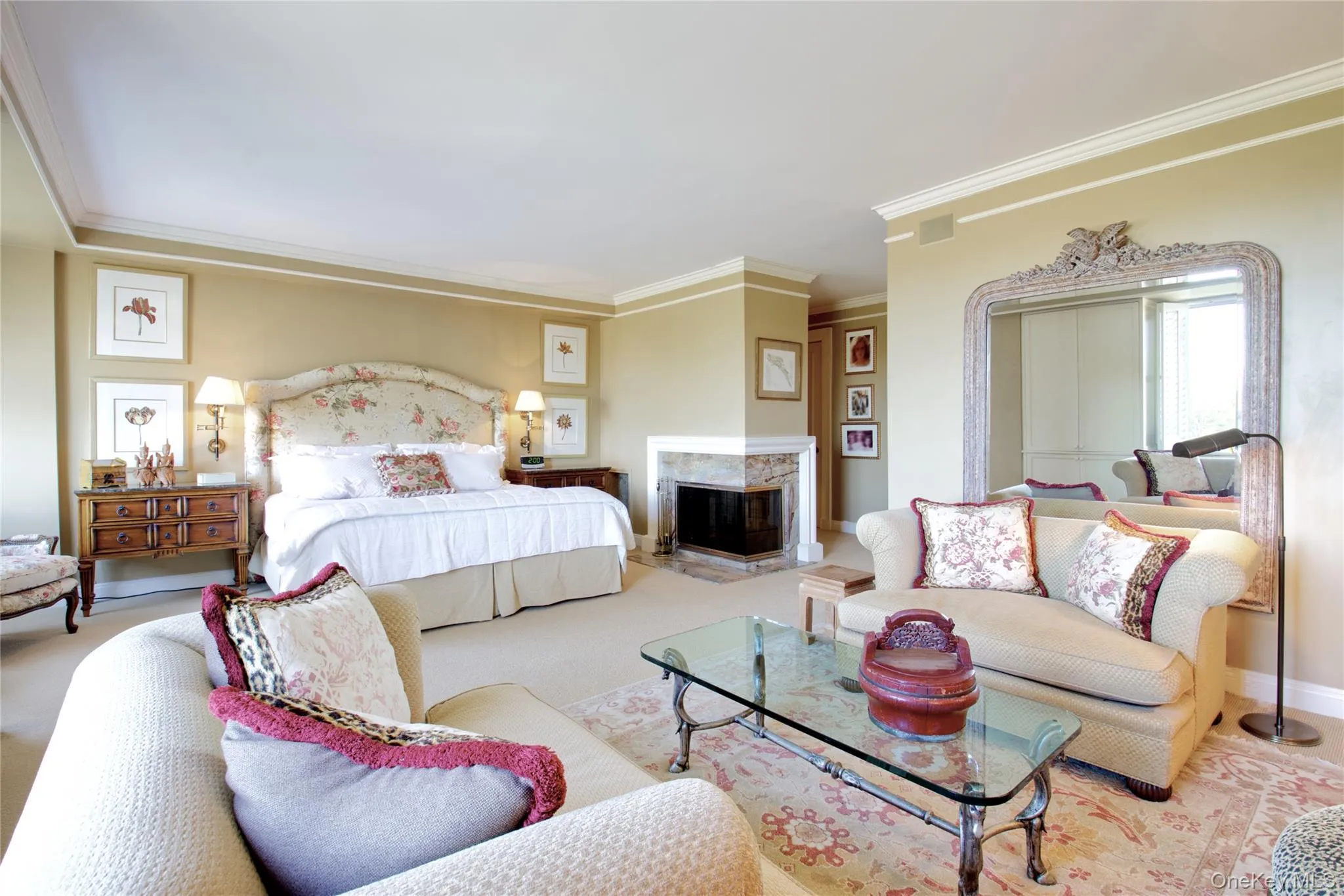 Bedroom with crown molding, carpet floors, and a fireplace Bedroom with crown molding, carpet floors, and a fireplace