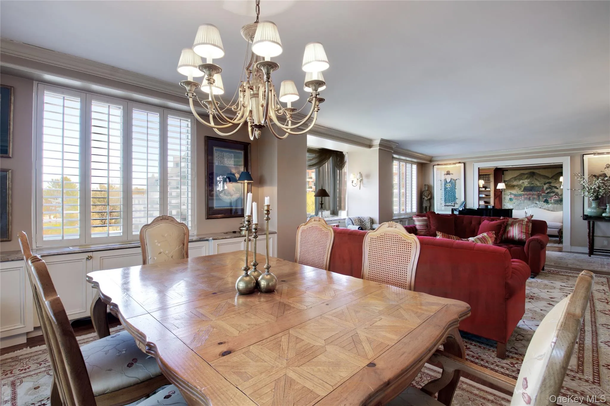Dining space with ornamental molding and a chandelier Dining space with ornamental molding and a chandelier