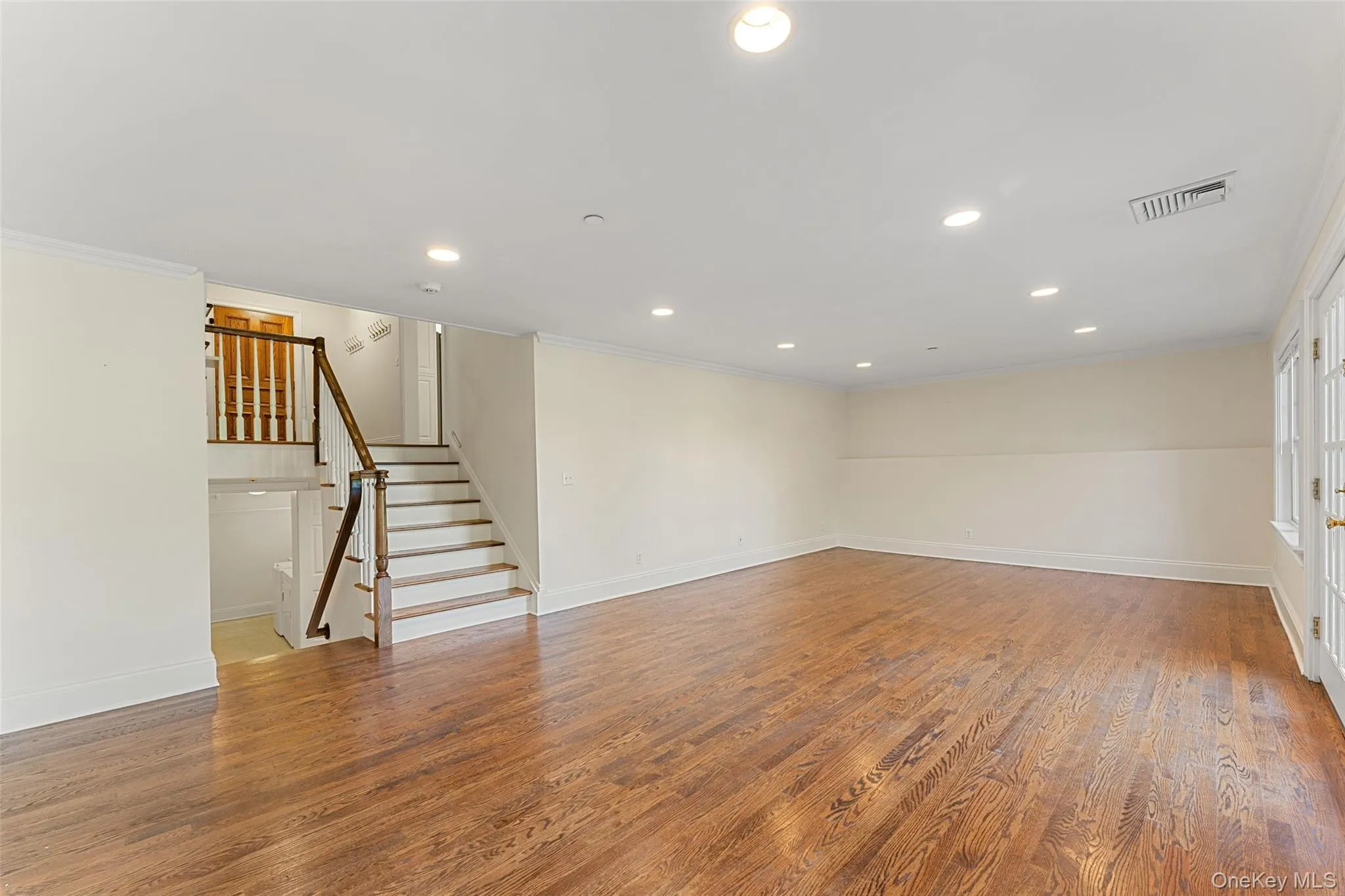 A few steps down from main level, flexible space (family room, dining room, etc) with French doors opening to backyard and patio A few steps down from main level, flexible space (family room, dining room, etc) with French doors opening to backyard and patio
