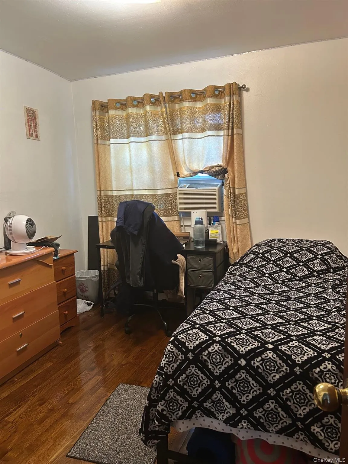 Bedroom featuring dark wood-type flooring and an office area Bedroom featuring dark wood-type flooring and an office area