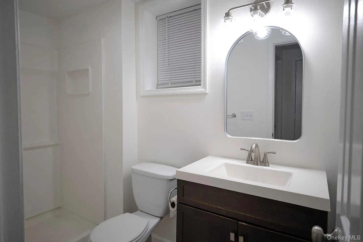 Full bathroom featuring vanity and a stall shower Full bathroom featuring vanity and a stall shower