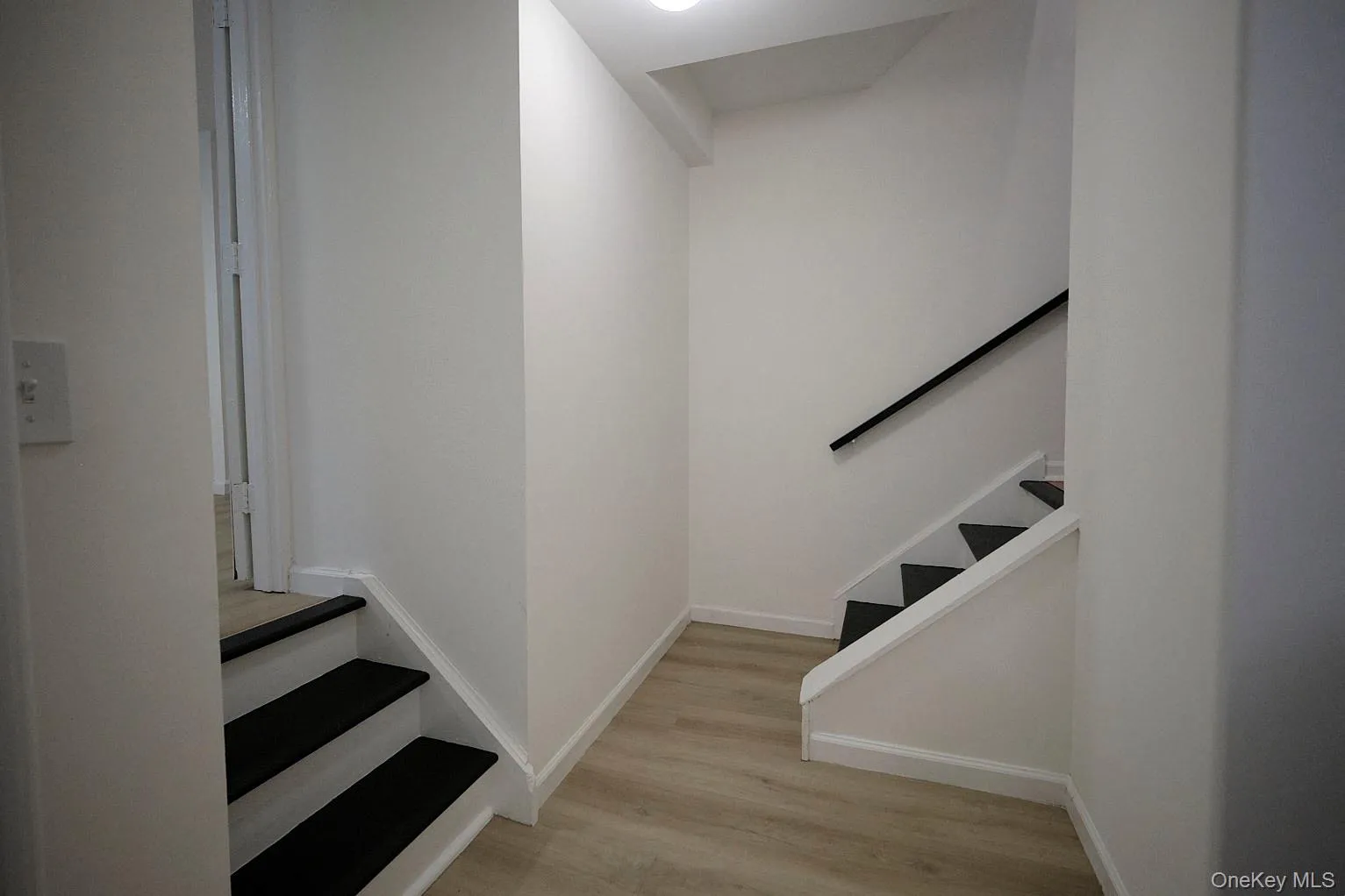 Staircase featuring wood finished floors and baseboards Staircase featuring wood finished floors and baseboards