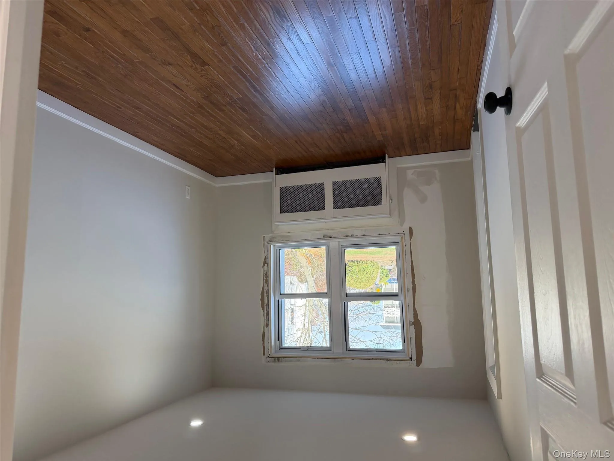 Spare room with radiator, dark wood-style flooring, and recessed lighting Spare room with radiator, dark wood-style flooring, and recessed lighting