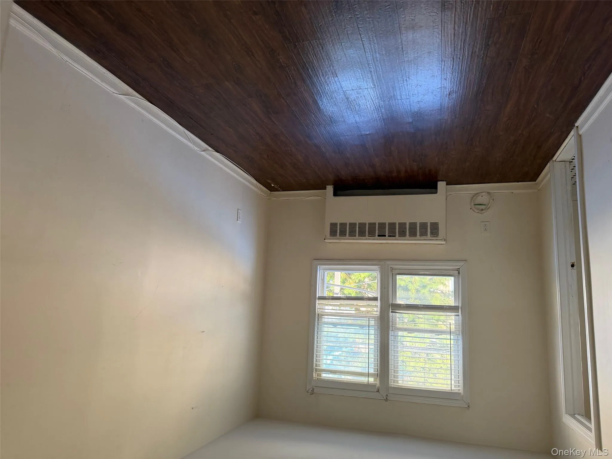 Empty room featuring radiator and dark wood-style flooring Empty room featuring radiator and dark wood-style flooring