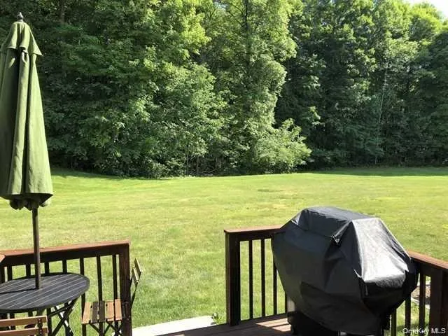 View of grassy yard featuring a deck View of grassy yard featuring a deck
