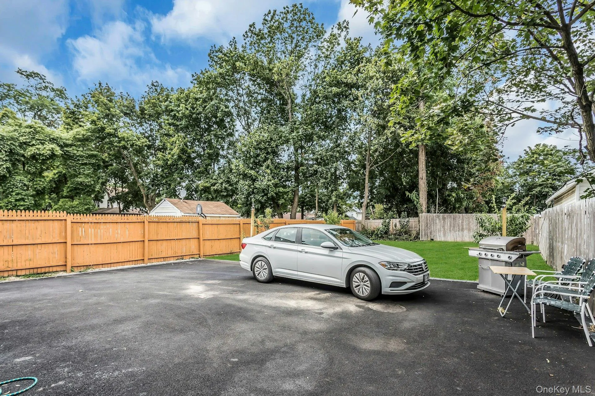 View of parking featuring view of scattered trees View of parking featuring view of scattered trees