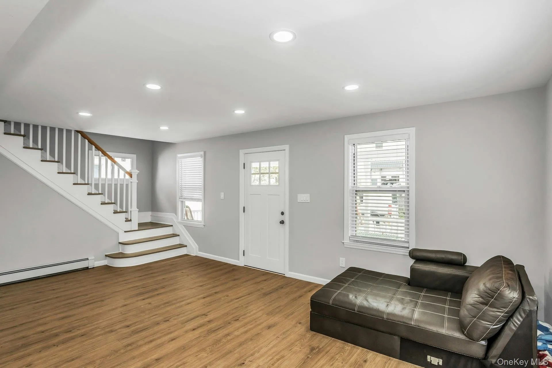 Entrance foyer featuring recessed lighting, stairway, and wood finished floors Entrance foyer featuring recessed lighting, stairway, and wood finished floors