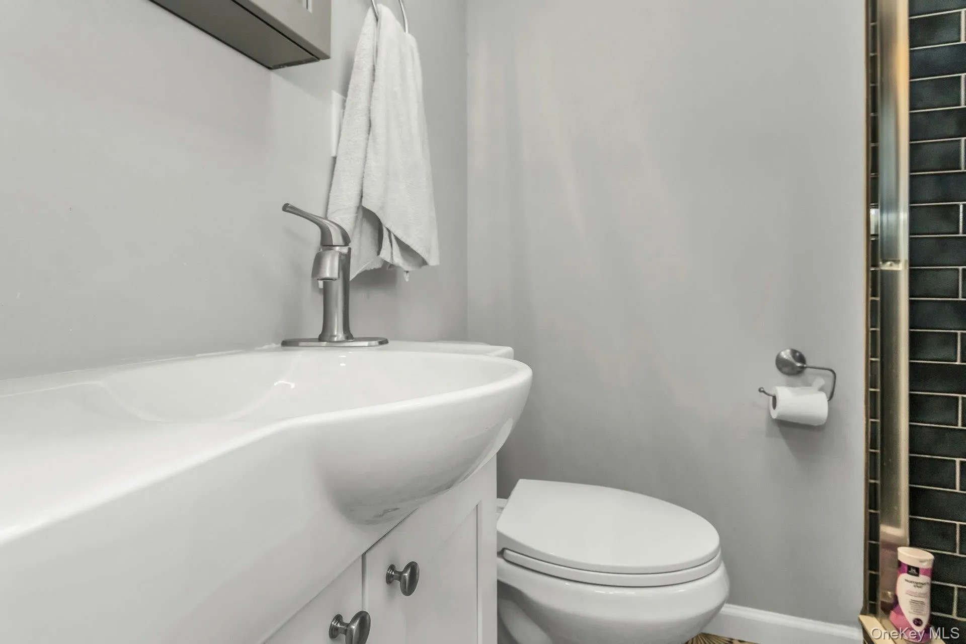 Bathroom featuring vanity and a shower Bathroom featuring vanity and a shower
