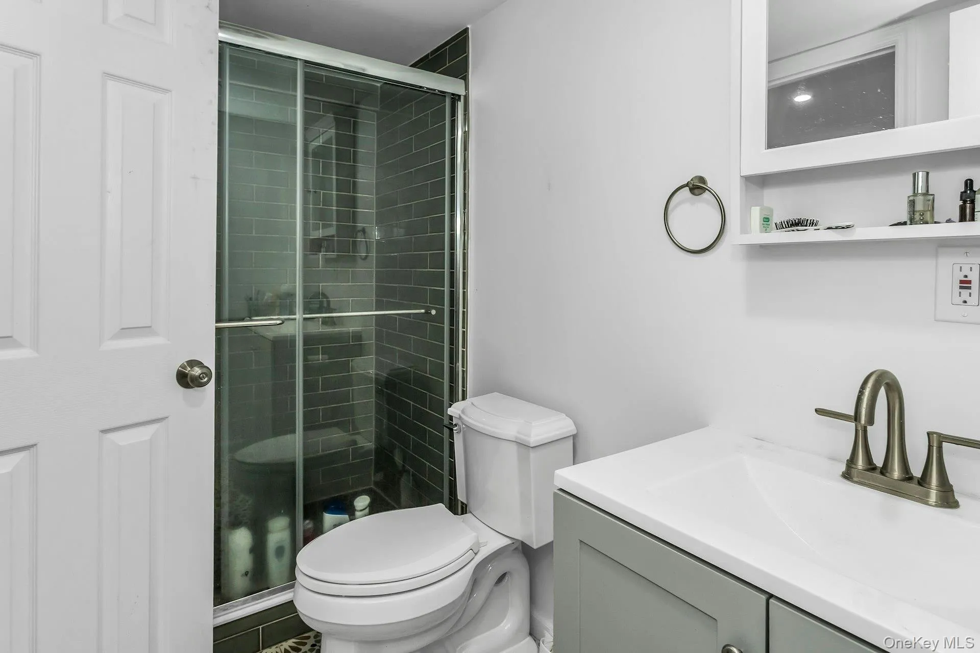 Full bath featuring vanity and a stall shower Full bath featuring vanity and a stall shower