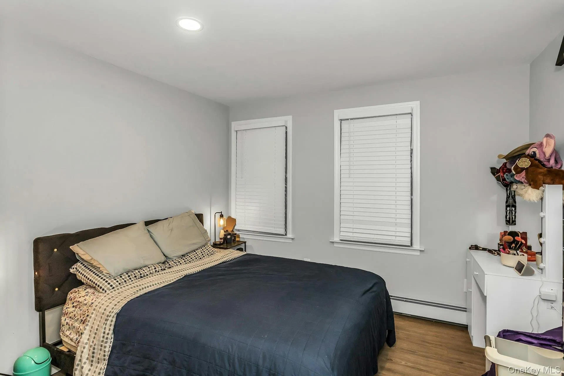 Bedroom featuring baseboard heating, wood finished floors, and recessed lighting Bedroom featuring baseboard heating, wood finished floors, and recessed lighting