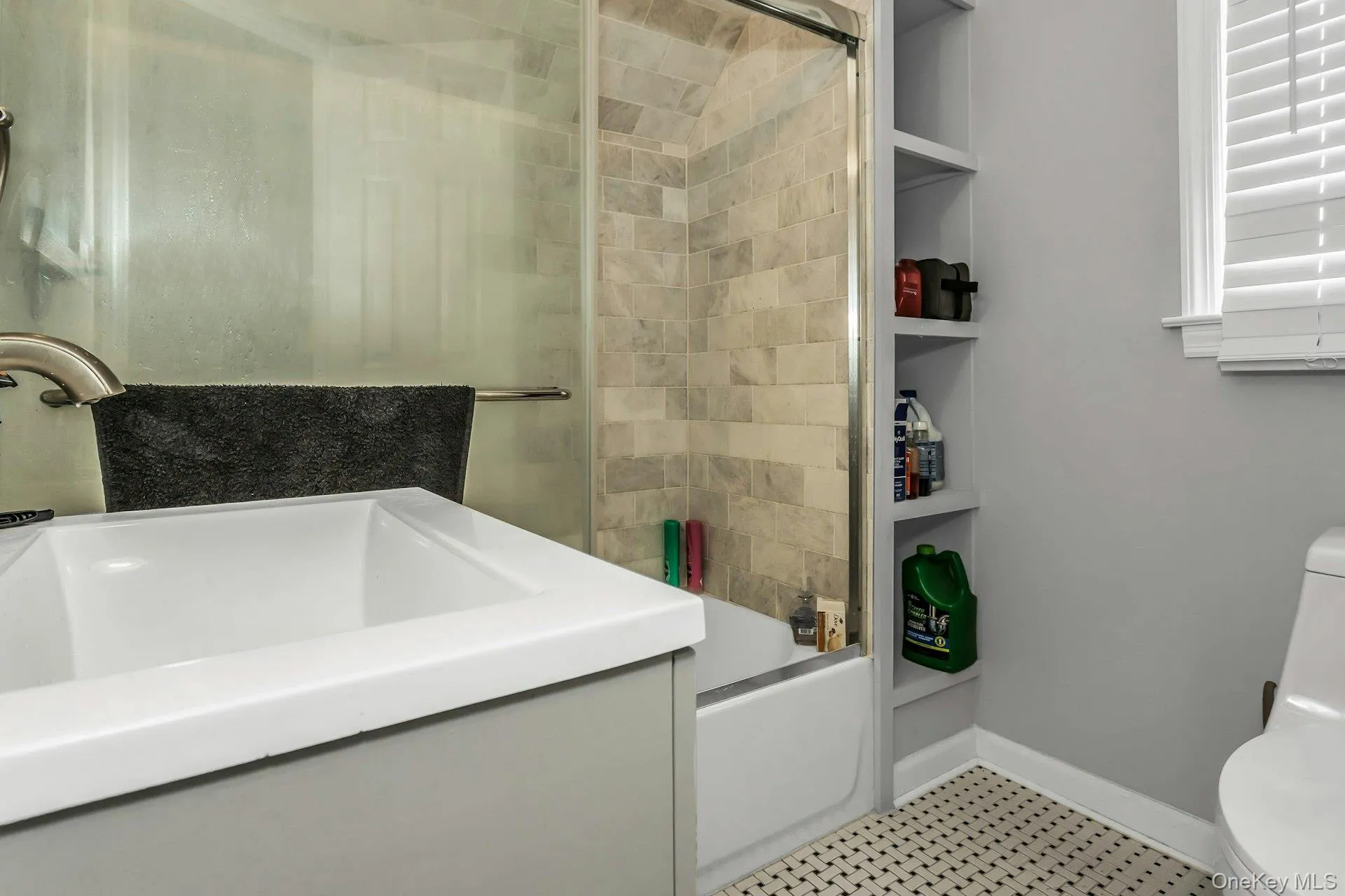 Full bath featuring combined bath / shower with glass door and vanity Full bath featuring combined bath / shower with glass door and vanity