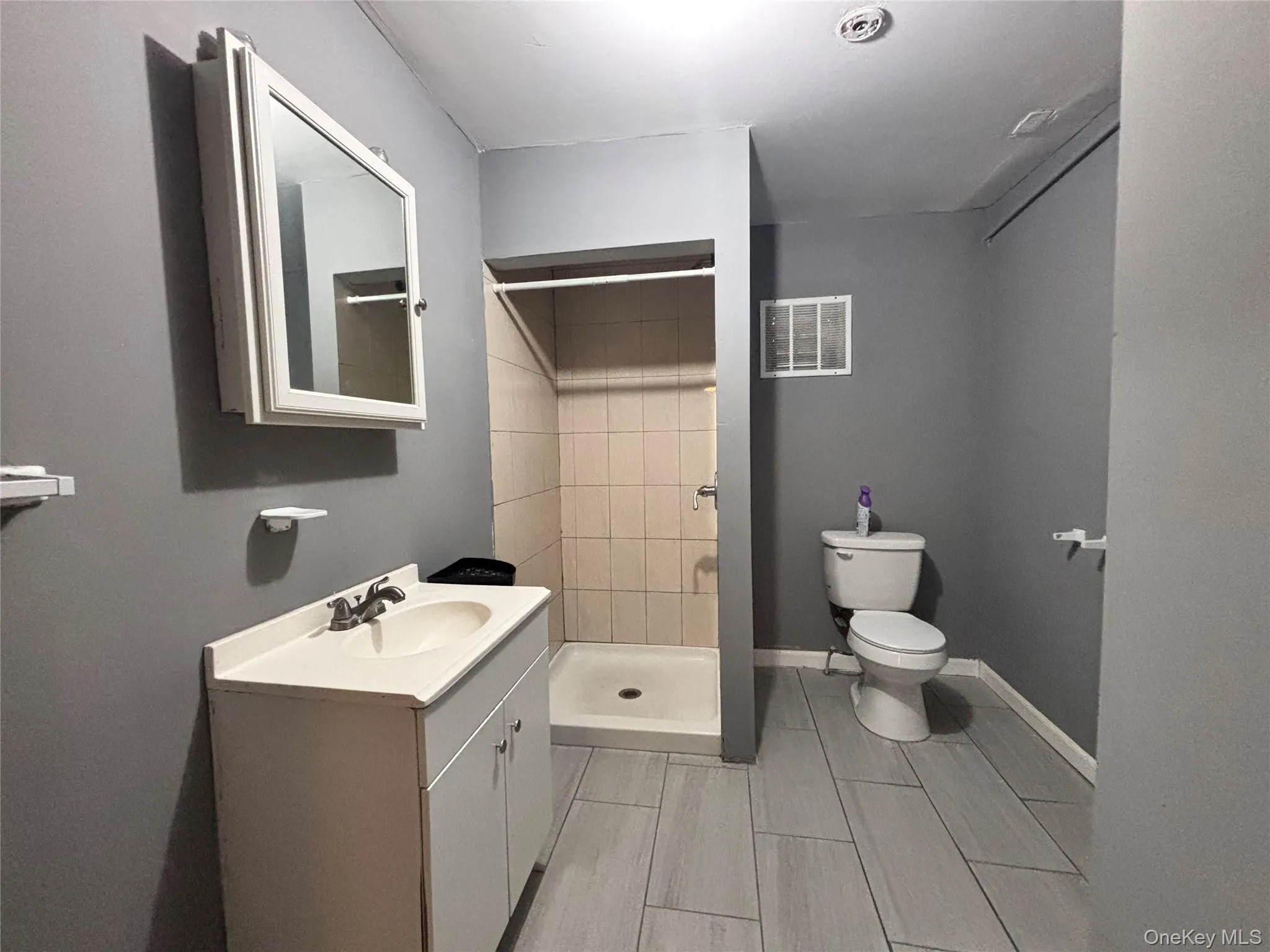 Bathroom featuring vanity and a shower stall Bathroom featuring vanity and a shower stall