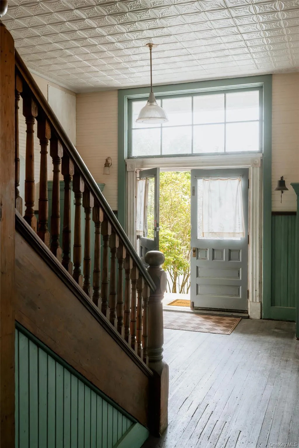 Entryway featuring stairs, an ornate ceiling, hardwood / wood-style floors, and wooden walls Entryway featuring stairs, an ornate ceiling, hardwood / wood-style floors, and wooden walls