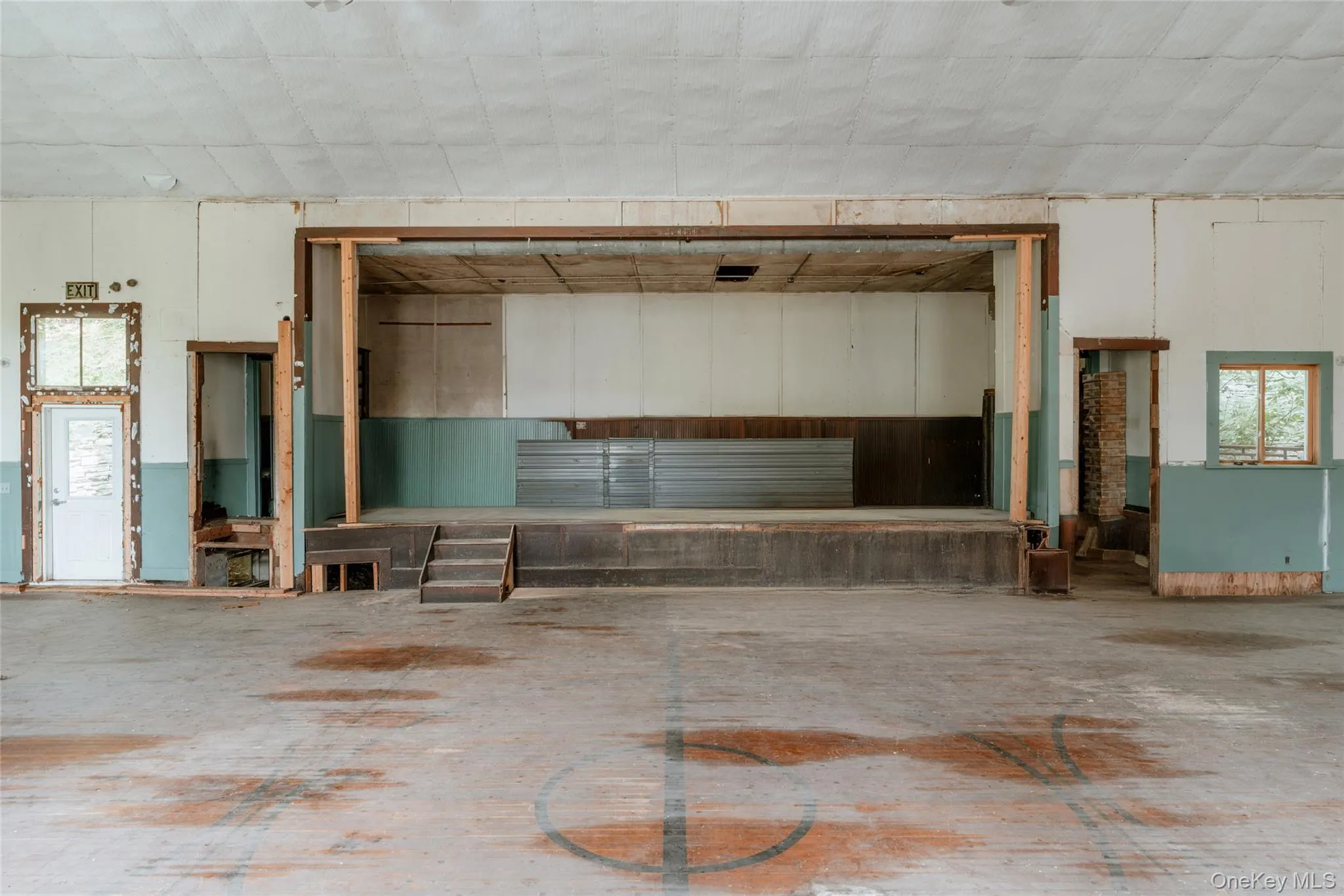 Miscellaneous room with a garage and concrete floors Miscellaneous room with a garage and concrete floors