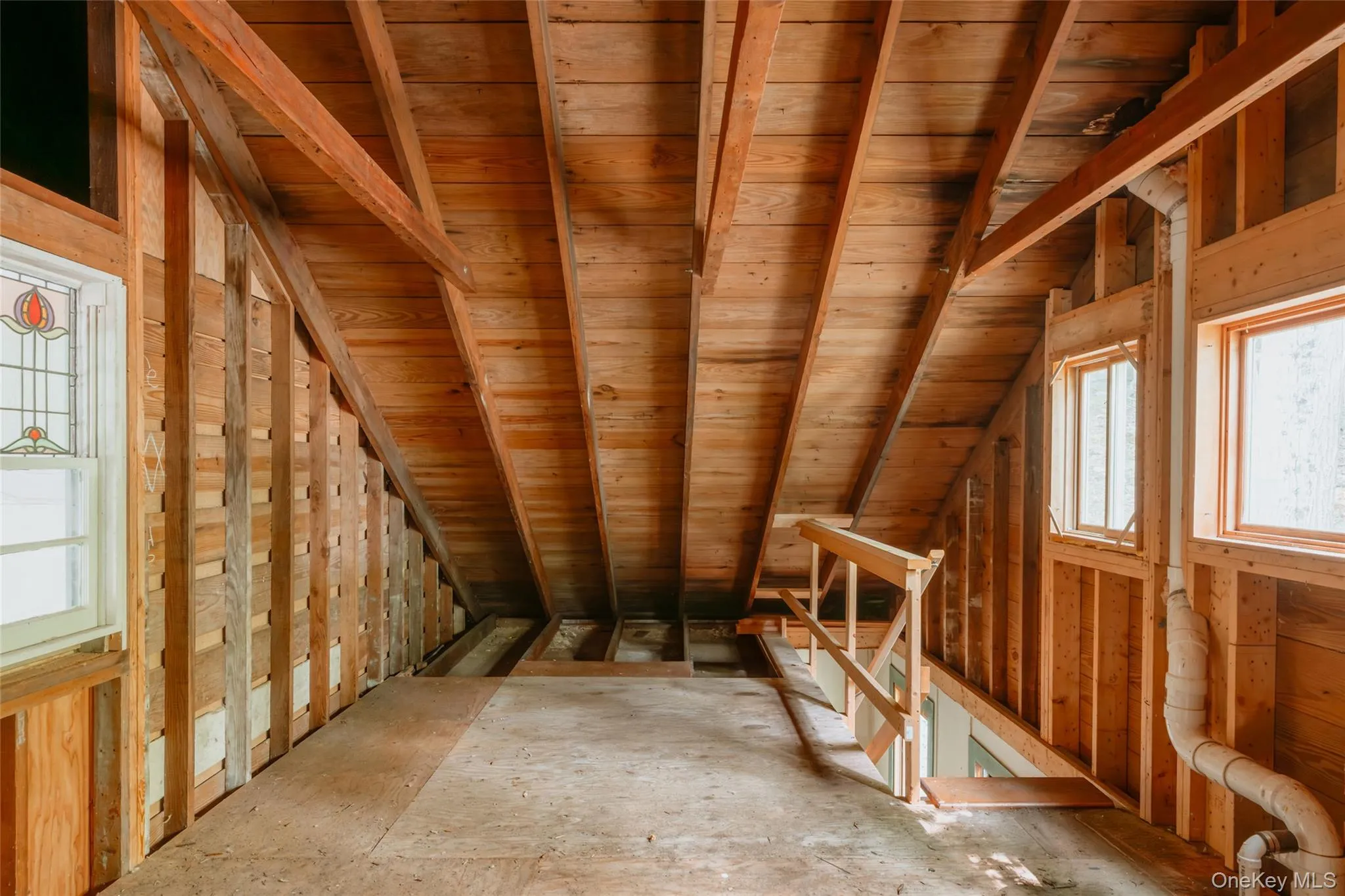 Unfinished attic featuring an upstairs landing Unfinished attic featuring an upstairs landing