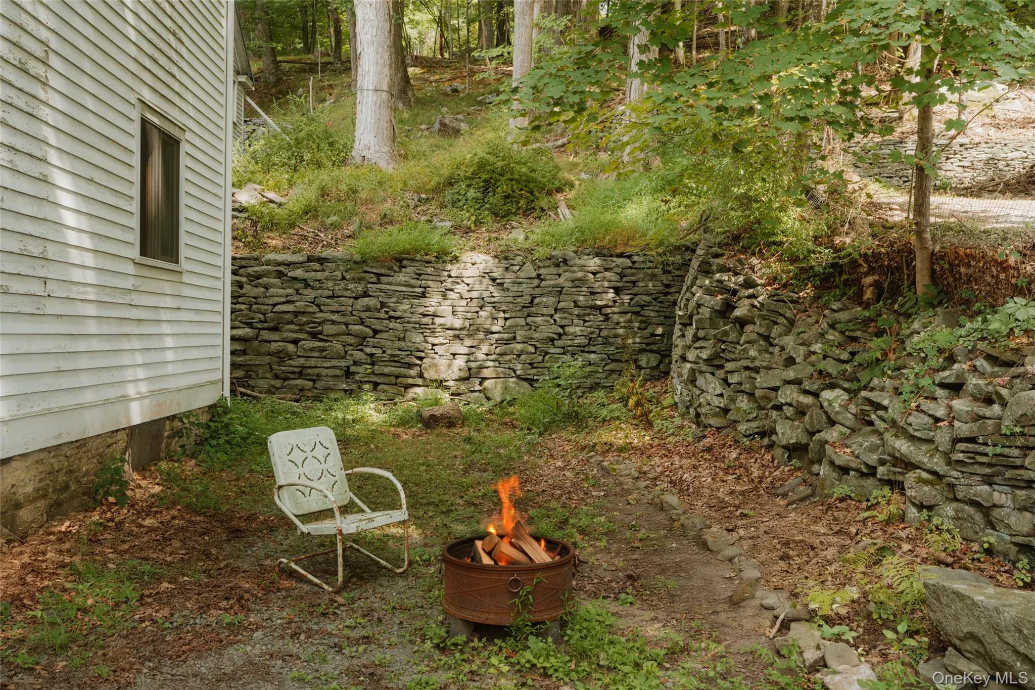 View of yard with an outdoor fire pit View of yard with an outdoor fire pit
