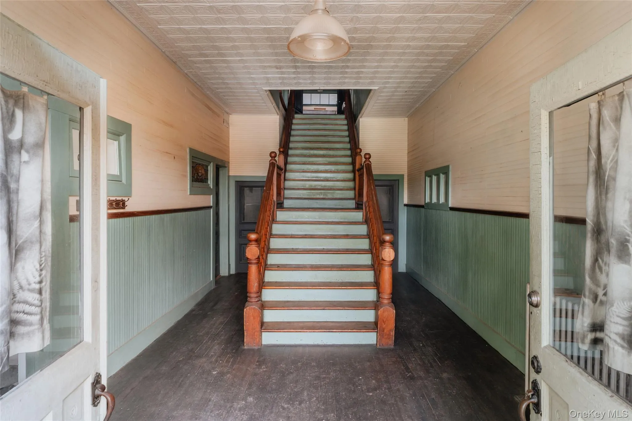 Stairway featuring hardwood / wood-style flooring and an ornate ceiling Stairway featuring hardwood / wood-style flooring and an ornate ceiling