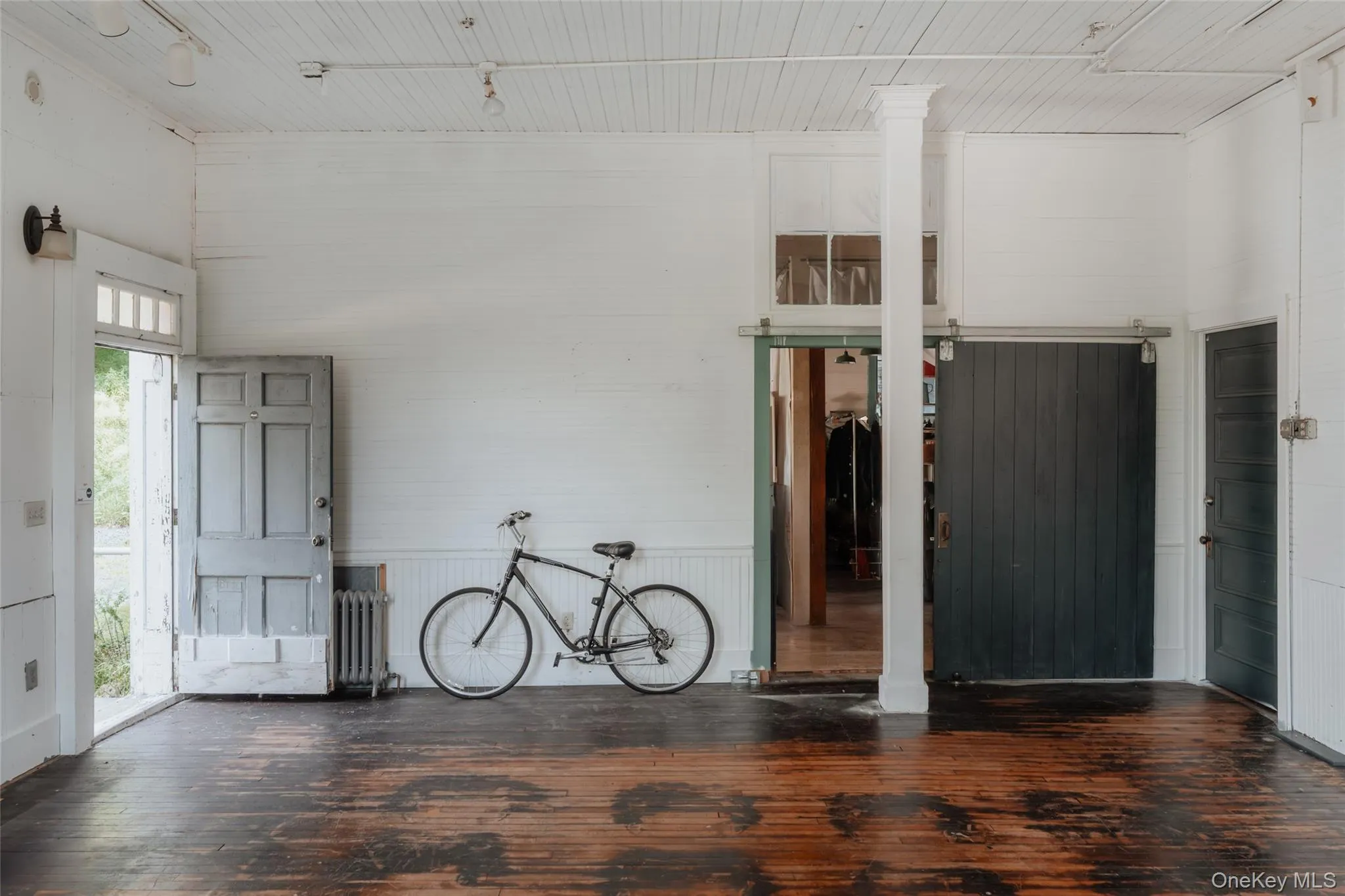 Garage featuring radiator and wood walls Garage featuring radiator and wood walls