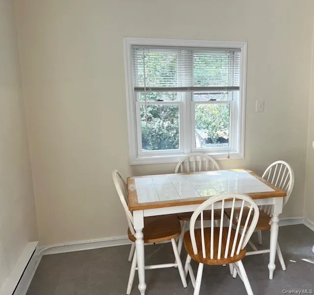 Dining space featuring a baseboard heating unit and baseboards Dining space featuring a baseboard heating unit and baseboards