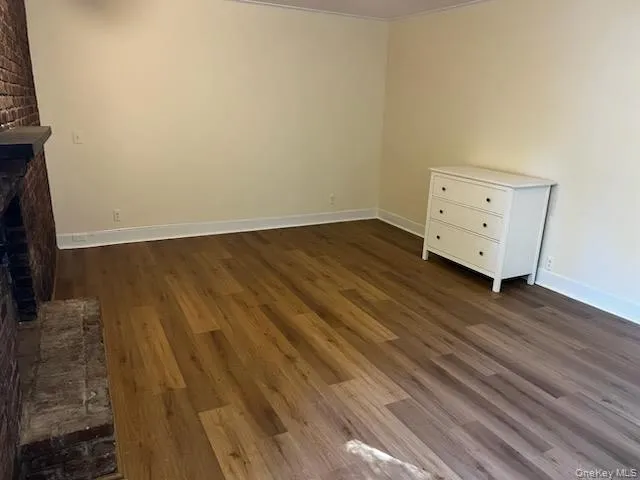Unfurnished bedroom featuring dark wood-type flooring Unfurnished bedroom featuring dark wood-type flooring