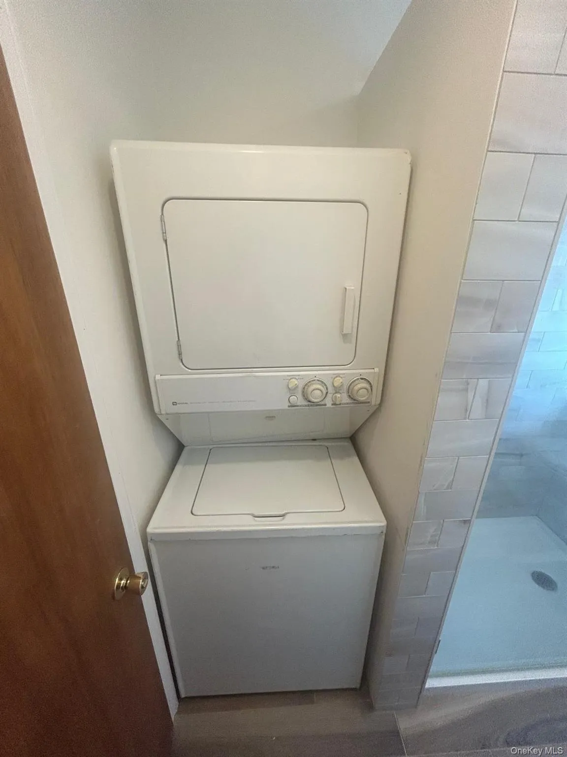 Laundry area with stacked washer / drying machine Laundry area with stacked washer / drying machine