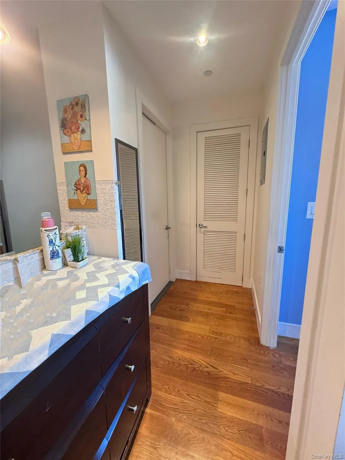 Hallway with light wood-type flooring and baseboards Hallway with light wood-type flooring and baseboards