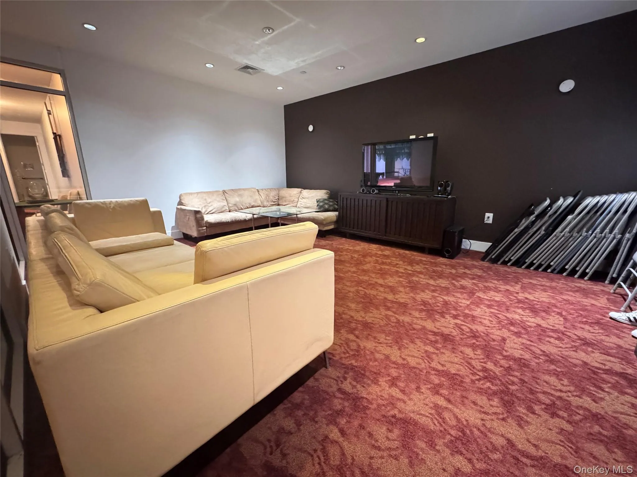 Living area with dark carpet and recessed lighting Living area with dark carpet and recessed lighting