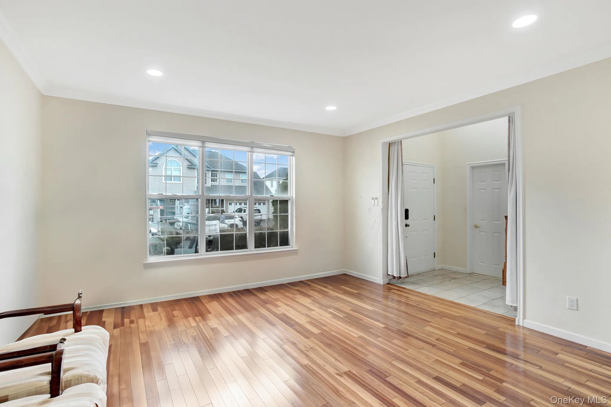 Unfurnished living room featuring light wood-style floors, crown molding, and recessed lighting Unfurnished living room featuring light wood-style floors, crown molding, and recessed lighting