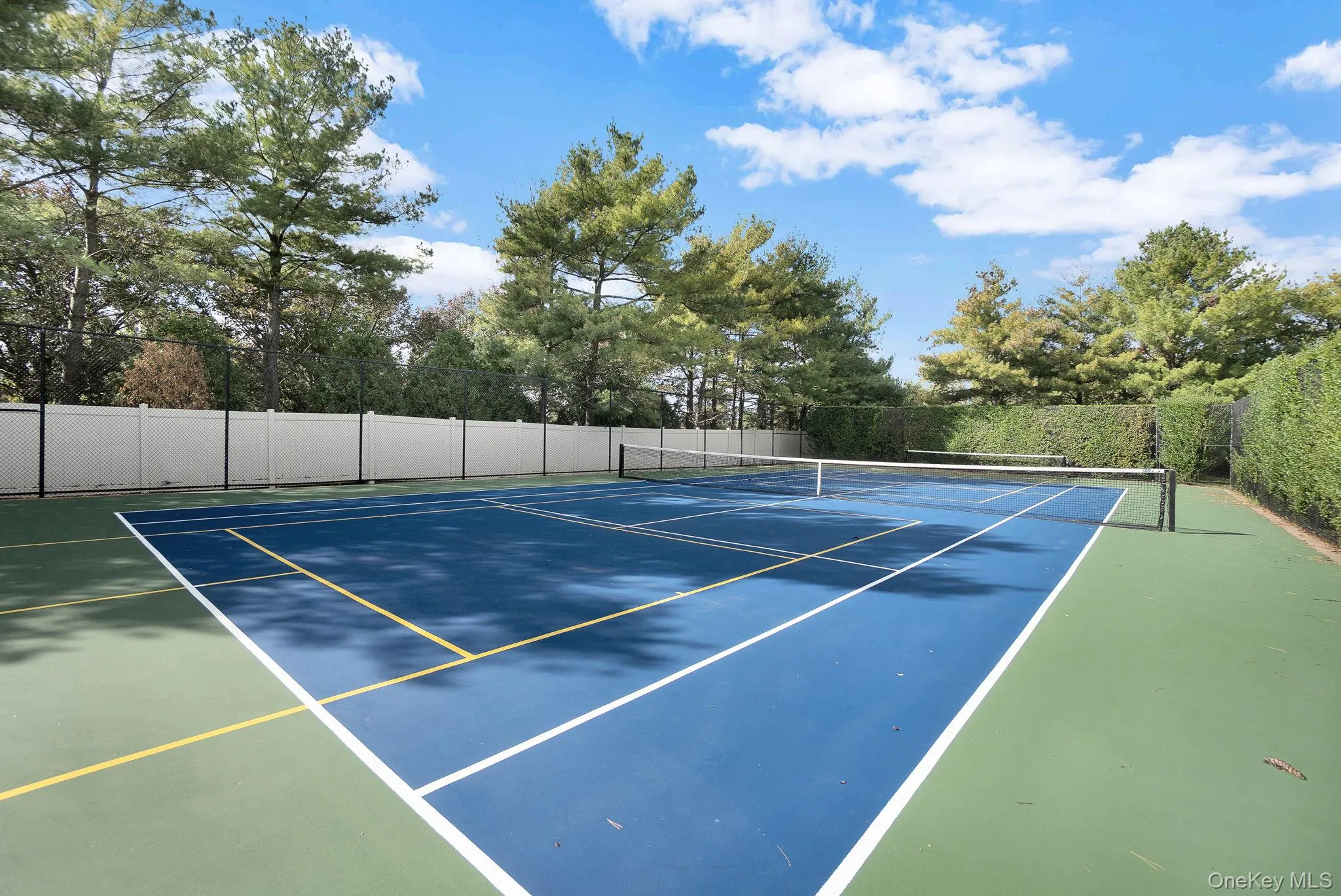 View of tennis court featuring community basketball court View of tennis court featuring community basketball court