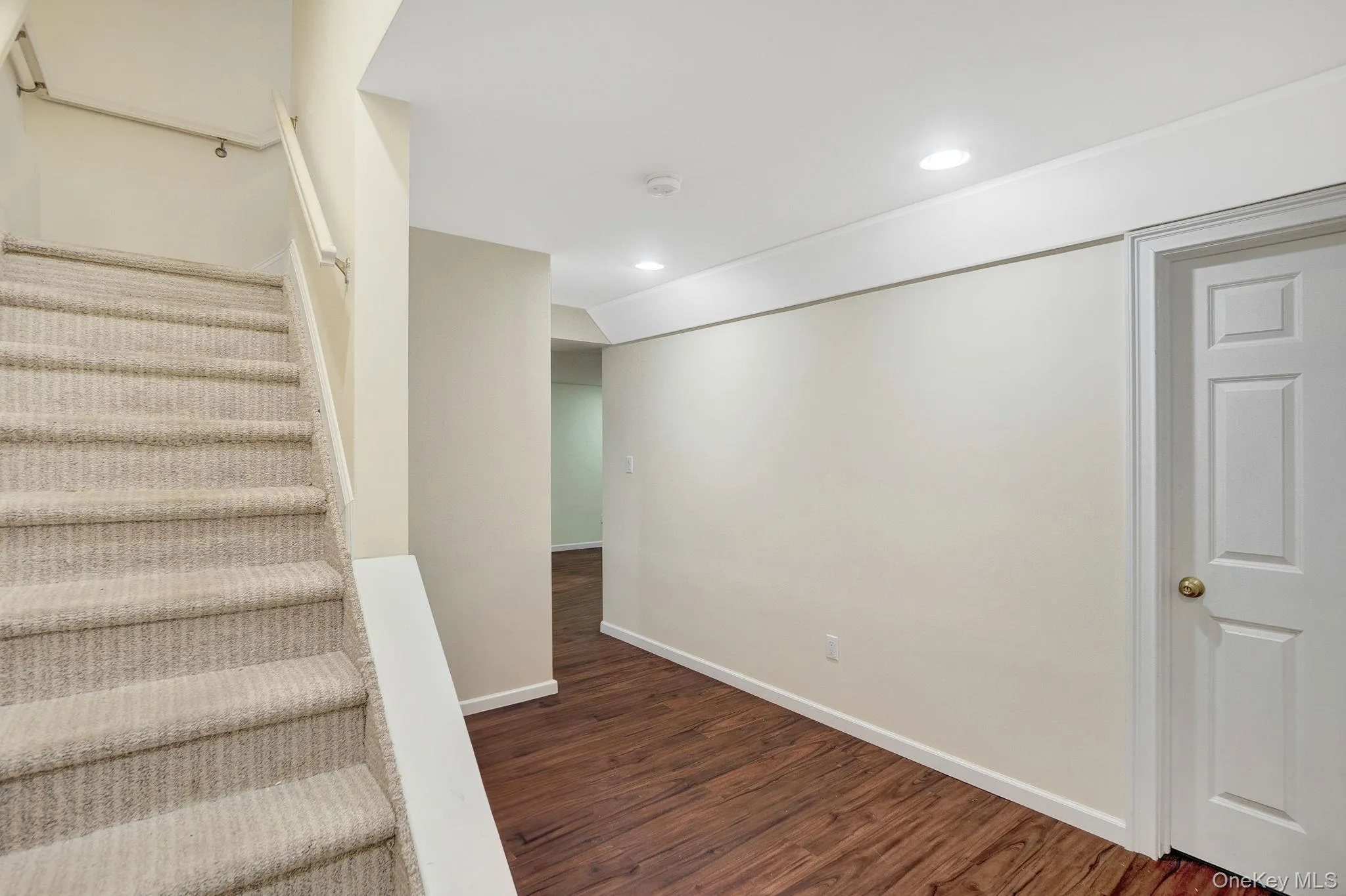 Staircase with wood finished floors and recessed lighting Staircase with wood finished floors and recessed lighting